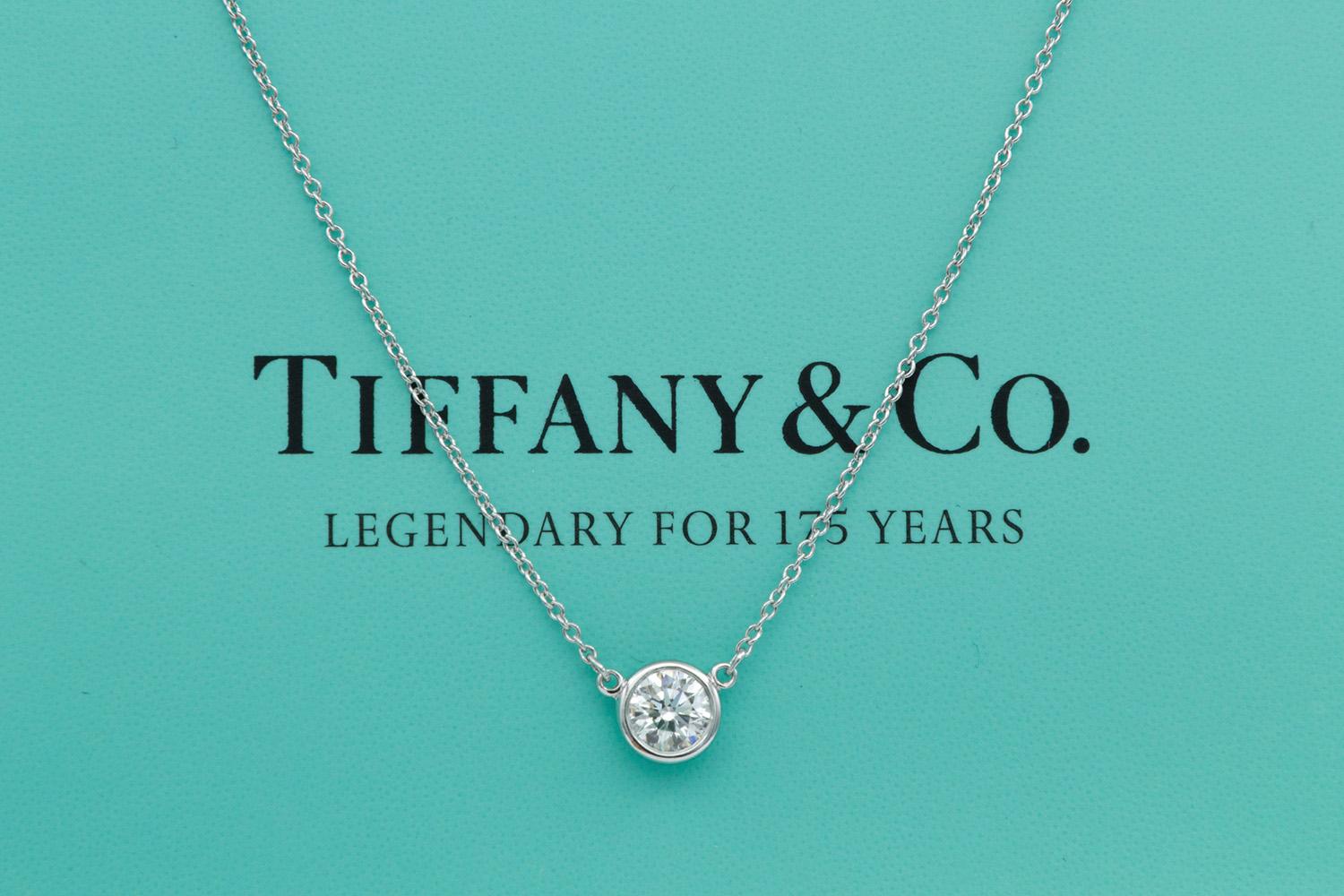 We arepleased to offer this Authentic Tiffany & Co. Elsa Peretti Diamonds By The Yard Single Diamond Pendant Platinum Necklace. Elsa Peretti, a true pioneer of design, translates all she sees in the natural world into jewelry that is sculptural,