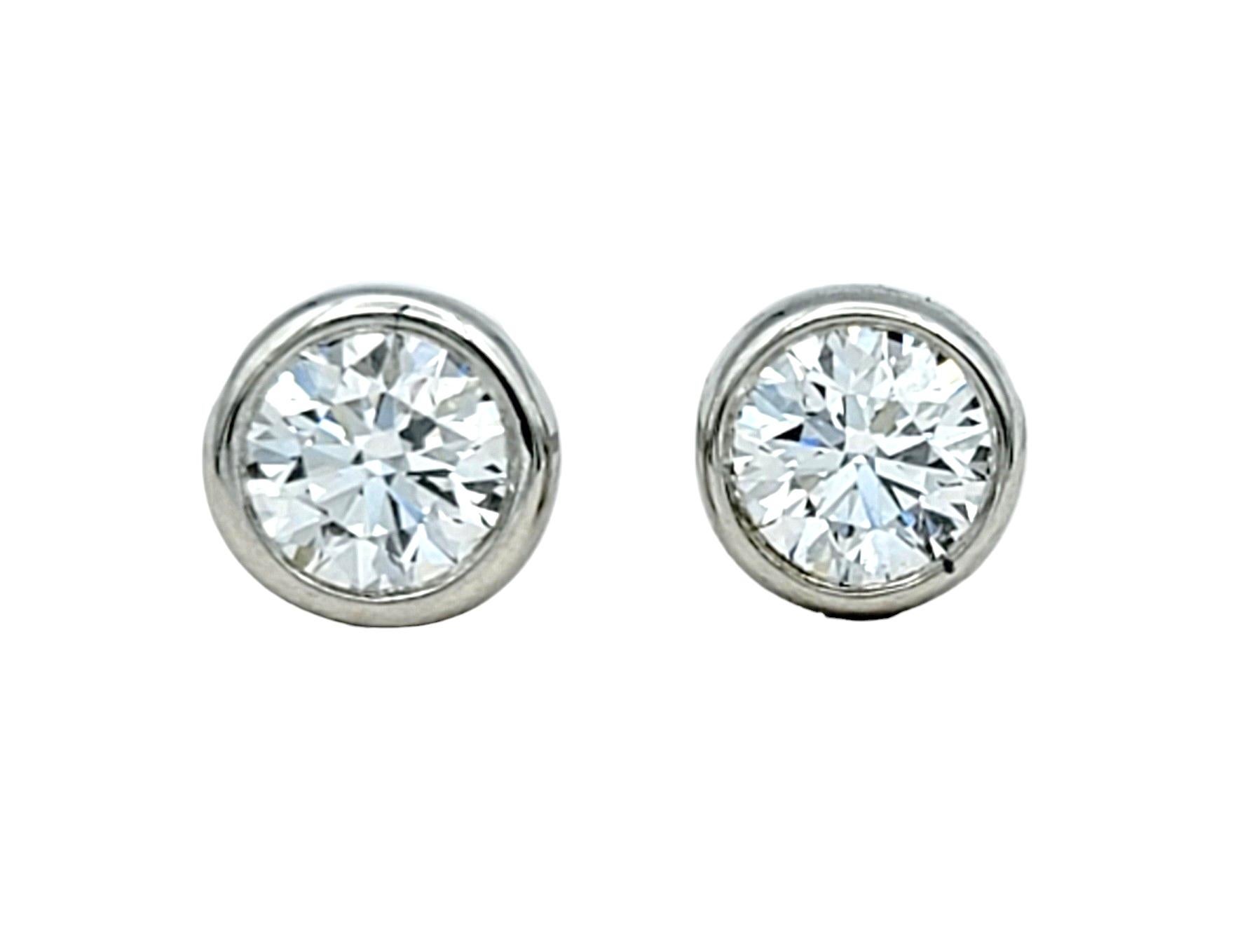 These Tiffany & Co. diamond stud earrings are the epitome of elegance, crafted from platinum and featuring brilliant diamonds securely bezel set. The bezel setting not only adds a sleek and modern touch to the design but also ensures the diamonds
