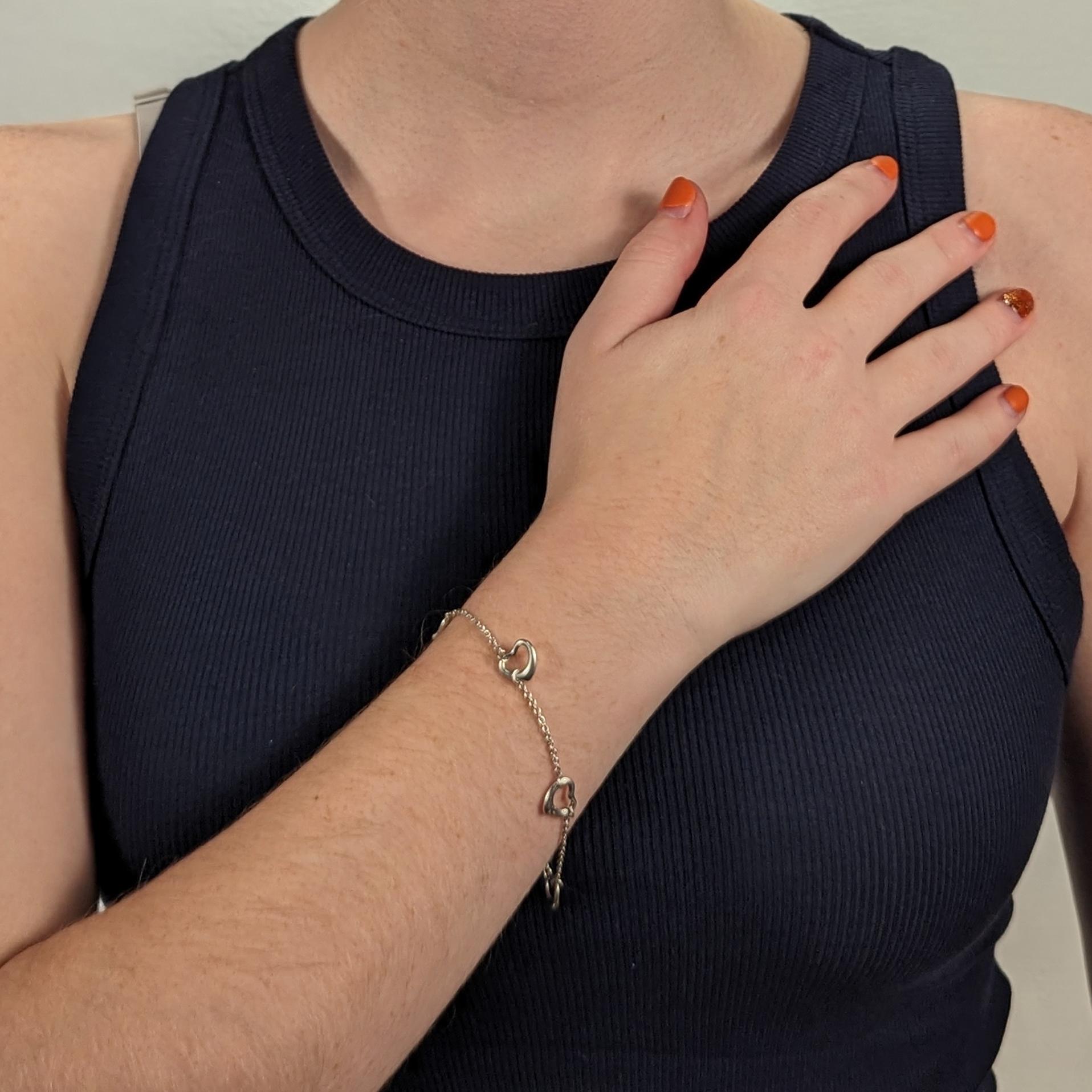 A fine Tiffany & Co. 5 Open Hearts  bracelet.

In sterling silver.

Designed by Elsa Peretti.

With 5 openwork hearts connected by small chain links and with a spring action clasp. 

Together with its original pouch.

Simply great design from