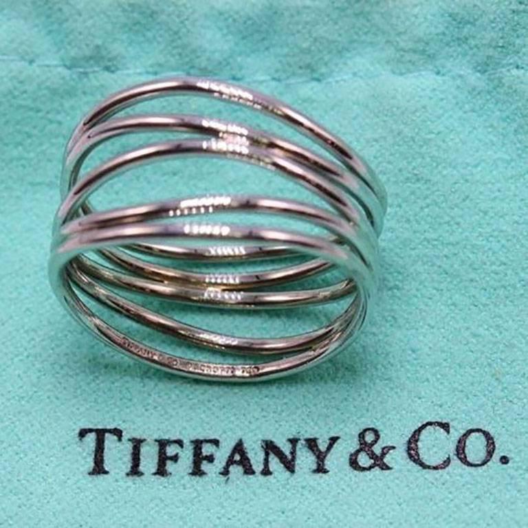 Tiffany & Co.
Style:  Elsa Peretti 5 Row Wave Ring
Width:  10 MM
Size:  6.5
Metal:  18KT White Gold
Hallmark:  TIFFANY&CO.©PERETTI750
Includes:  T&C Jewelry Pouch

Retail Value:  $1,800 + Tax = $1,939.50