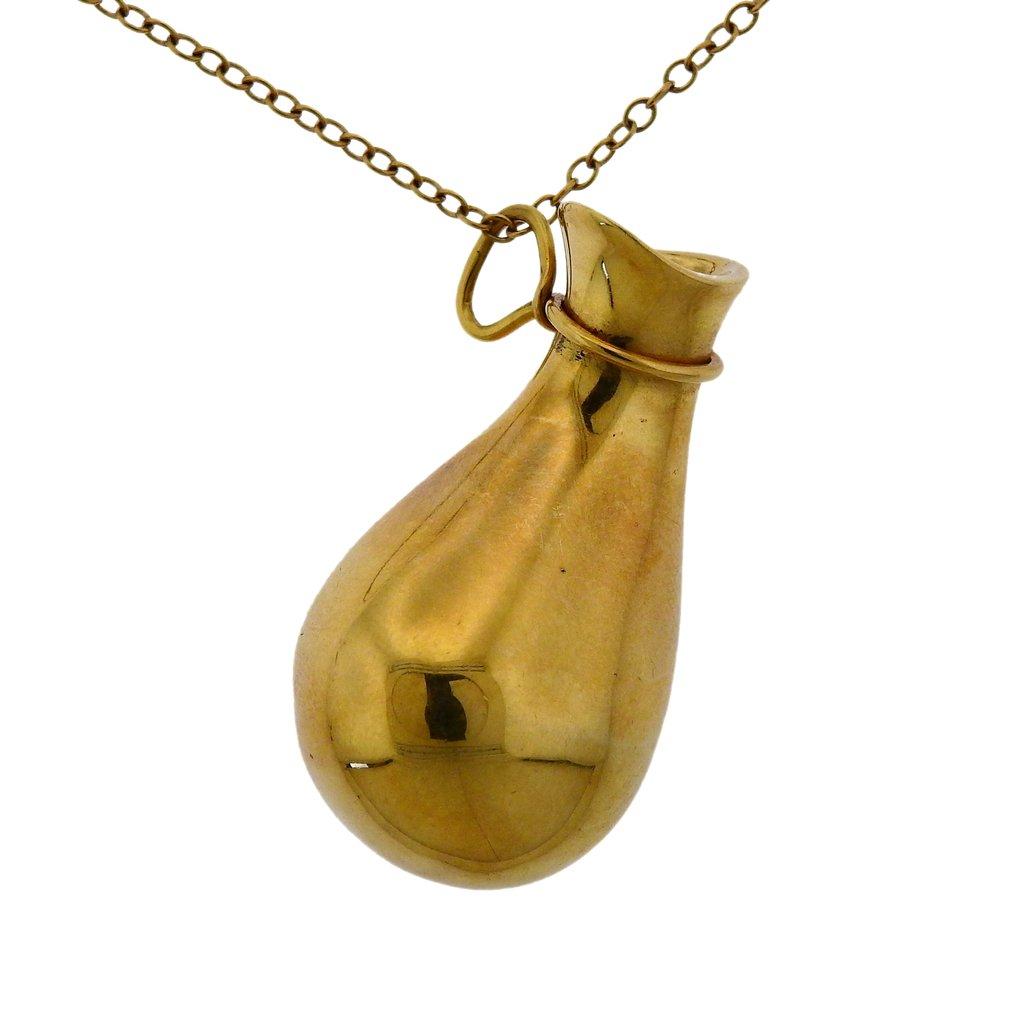 18k yellow gold necklace by Elsa Peretti, created for Tiffany & Co, featuring bottle pendant. Necklace is 24