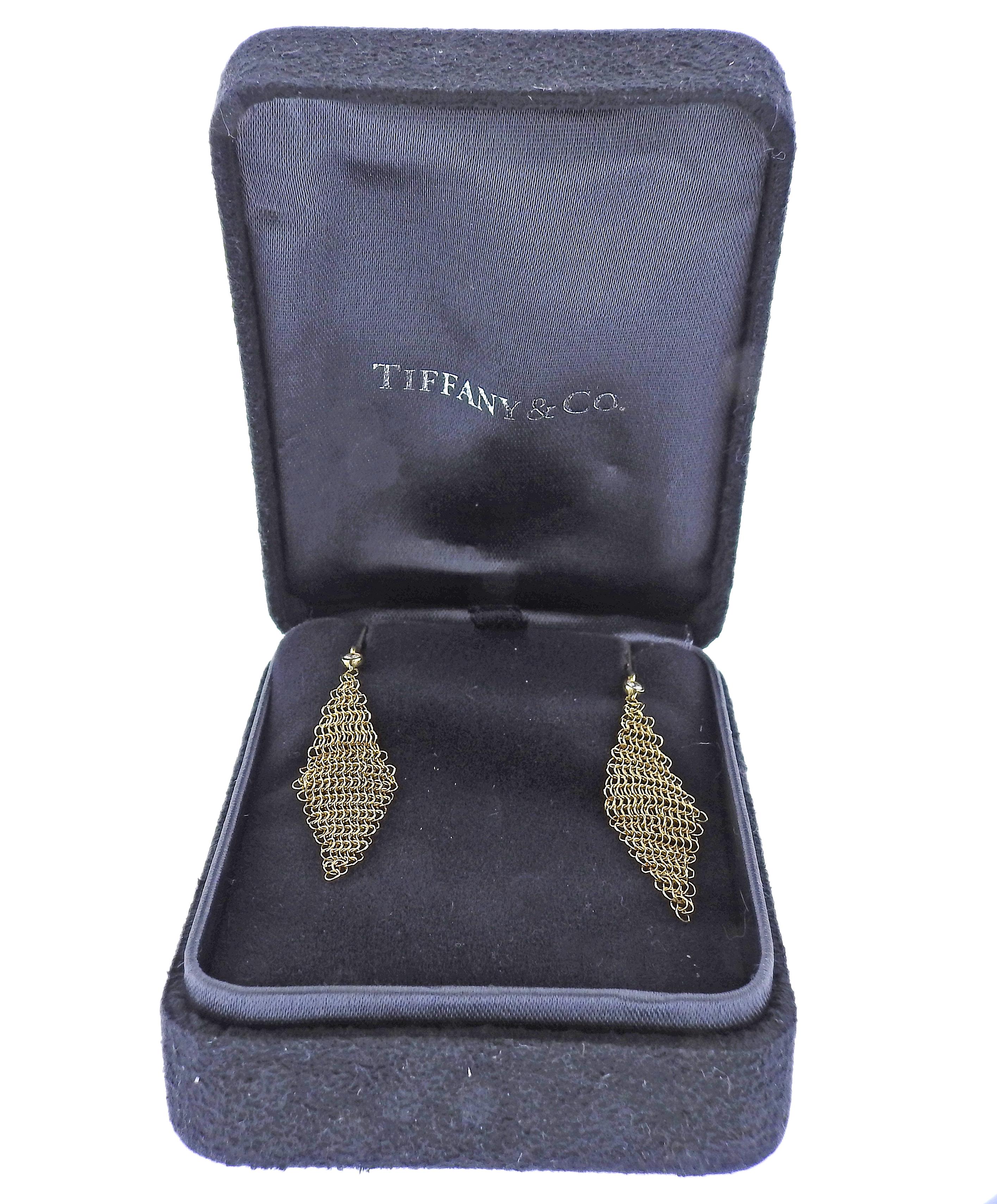 Pair of 18k gold signature mesh earrings in 18k gold, designed by Elsa Peretti for Tiffany & Co, with 1 diamond each. Earrings are 52mm long and approx. 12mm wide. Marked: T & Co, 750. Come in original box. Weight - 1.8 grams.