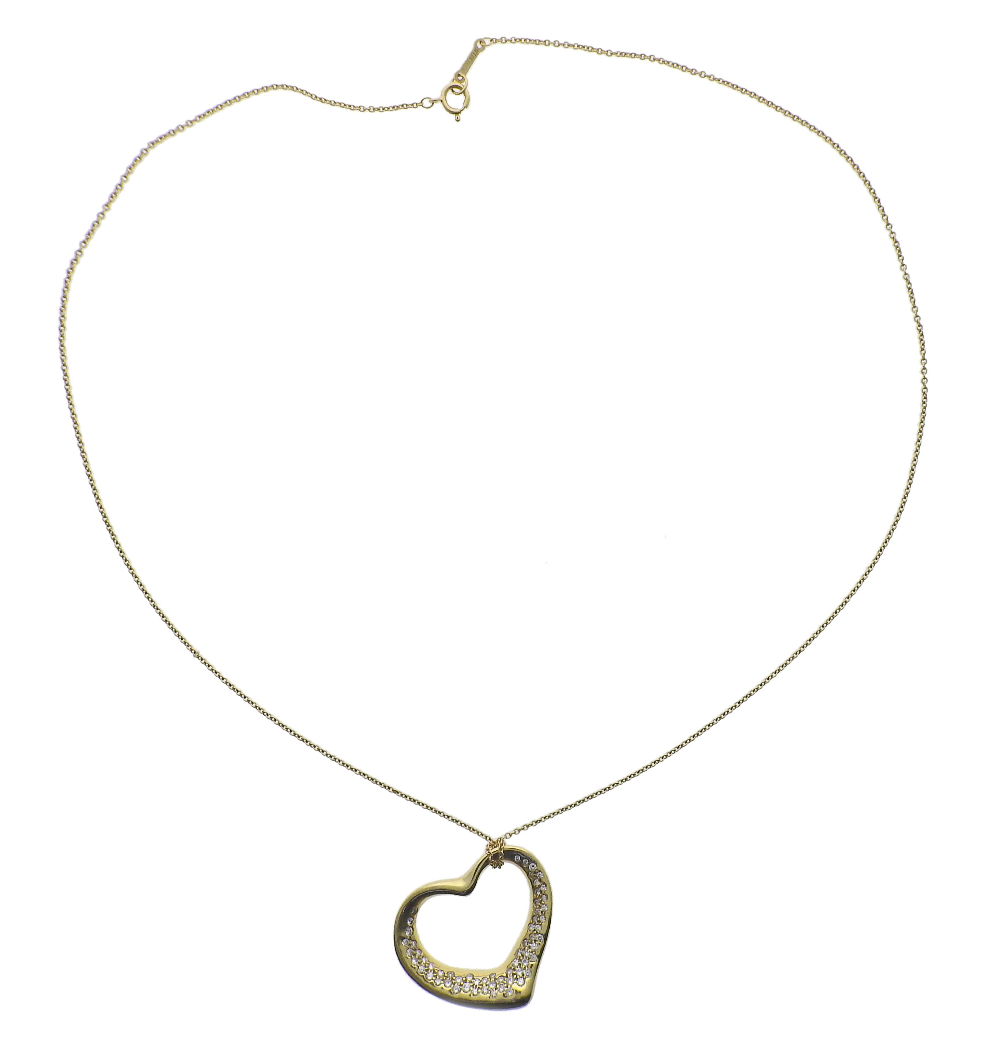 18K yellow gold open heart pendant necklace by Elsa Peretti for Tiffany & Co, set with 0.80ctw in G/VS diamonds. Neckalce measures 17