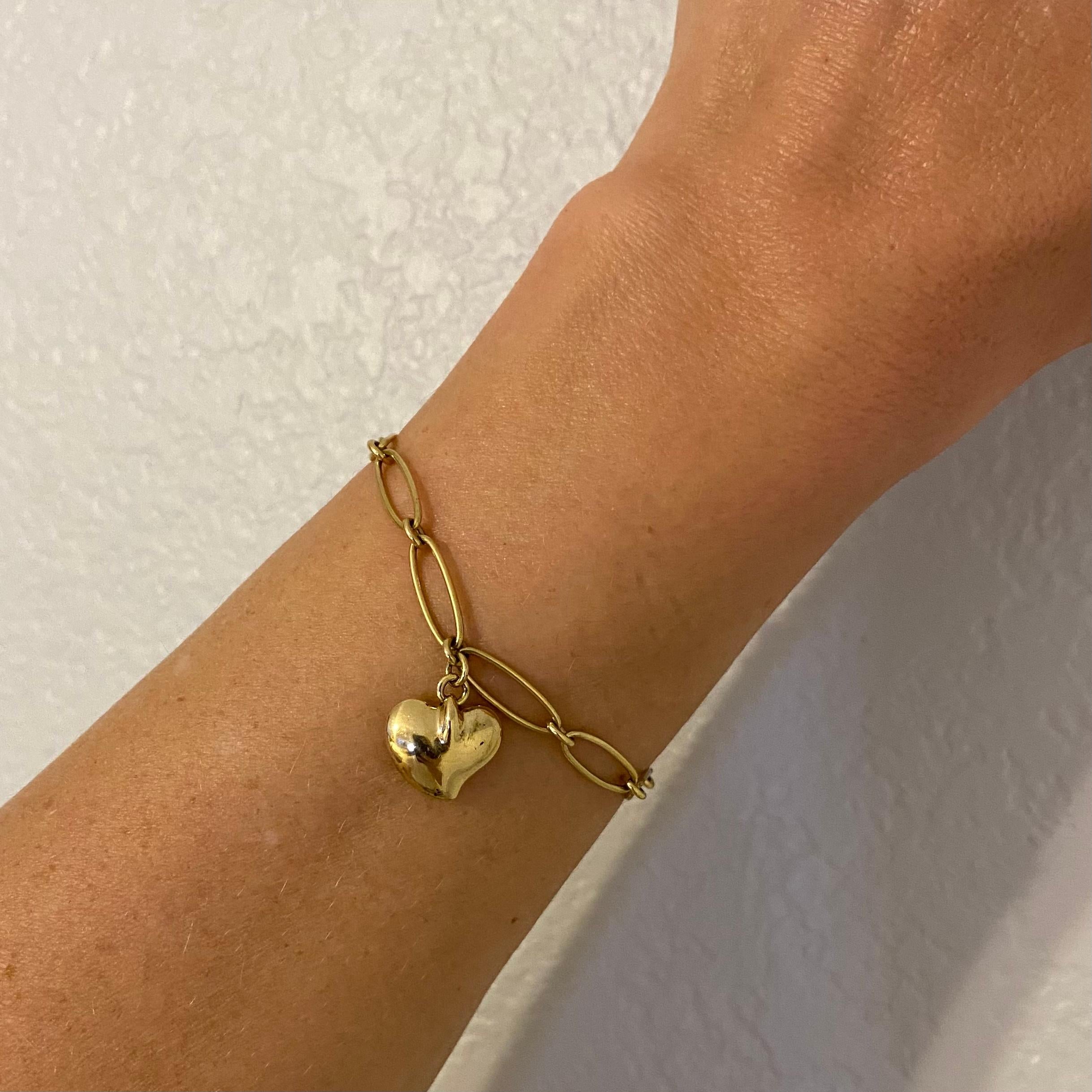Iconic TIFFANY & CO Elsa Peretti 18K Yellow Gold open Link Bracelet, suspending a Heart Charm. Marked:  Tiffany & Co. 750 and signed: Elsa Peretti SPAIN. Measuring approx. 7”l x 0.20”w. For that Special Someone…including you! 