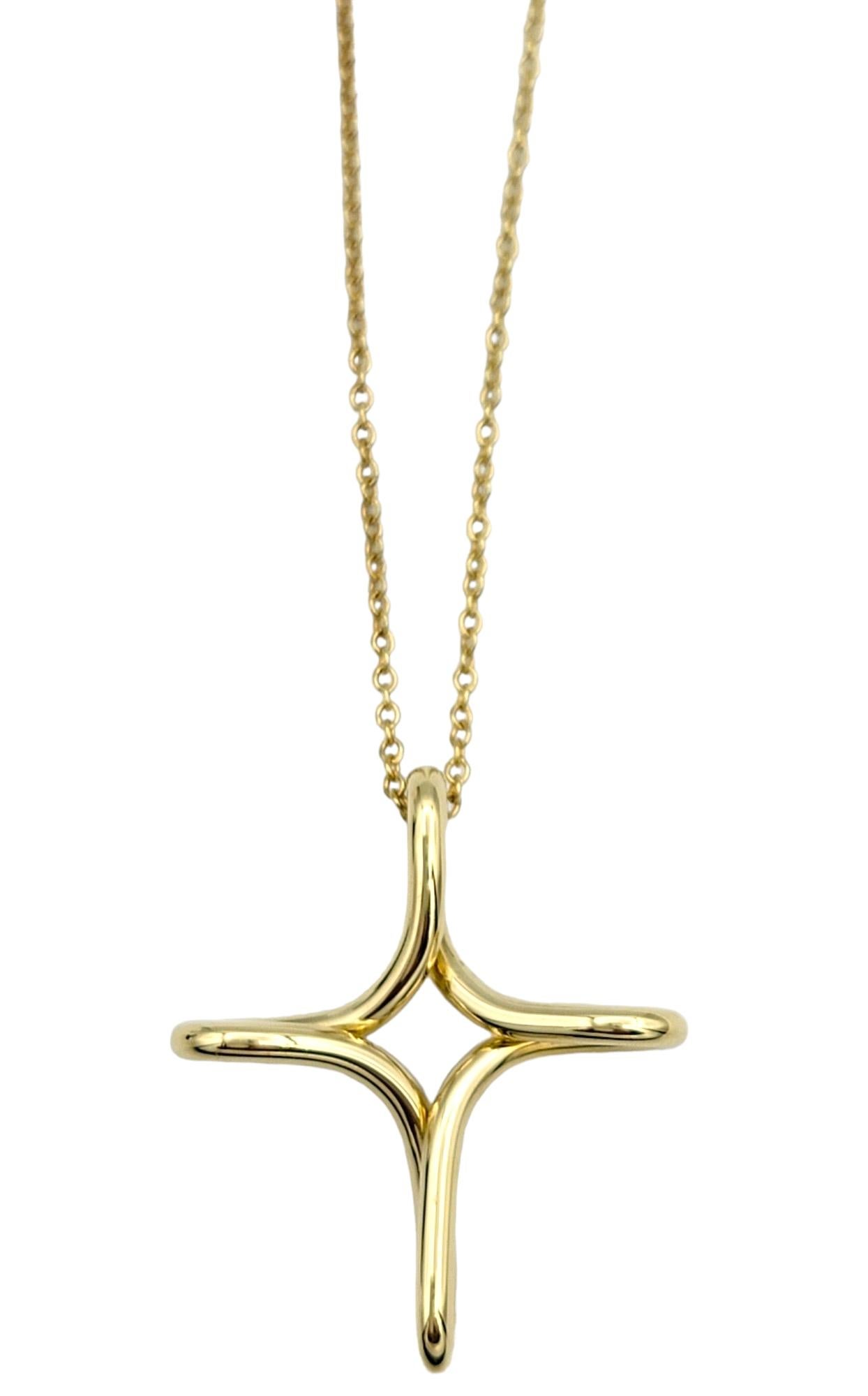 Embrace timeless elegance with this iconic cross pendant necklace, designed by the legendary Elsa Peretti for Tiffany & Co. Crafted from luxurious 18K yellow gold, this exquisite piece exudes sophistication and grace.

The infinity cross pendant