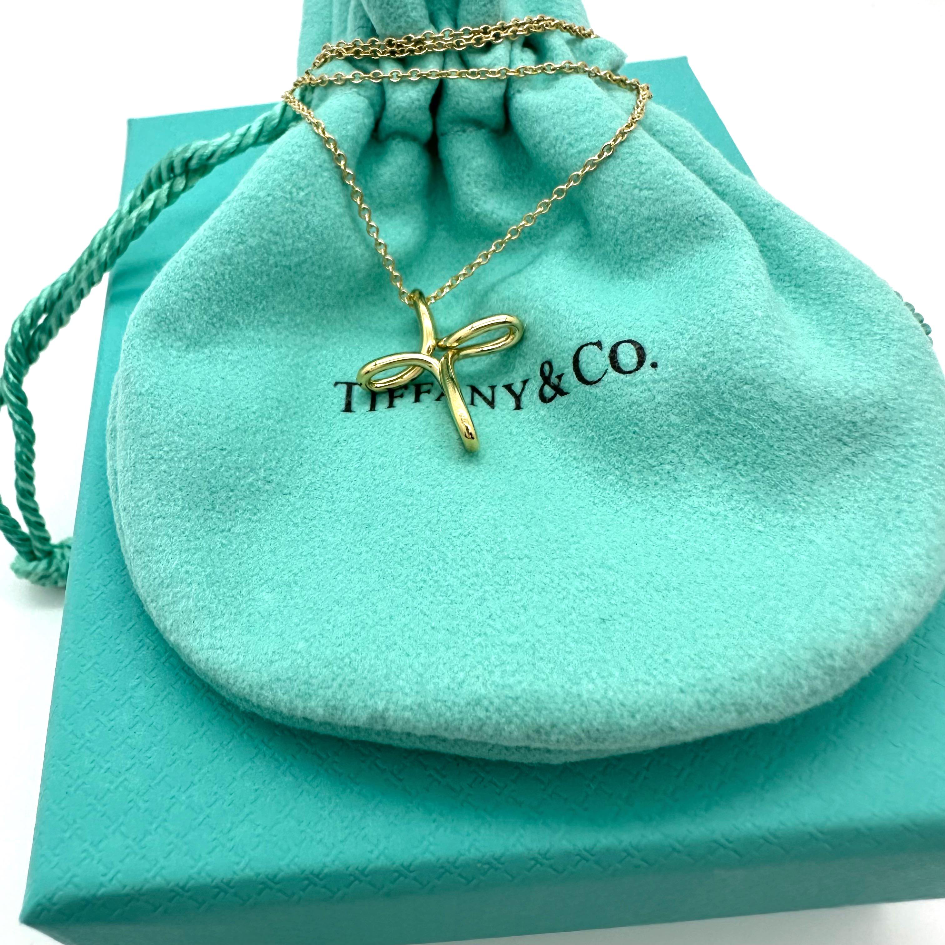 Tiffany & Co. Elsa Peretti Infinity Cross Pendant Necklace
Style:  Pendant
Ref. number:  60018533
Metal:  18k Yellow Gold
Size:  Small
Measurements: 16' Chain - 15 mm Cross
Hallmark:  T&Co. ©PERETTI Au750 SPAIN on Cross & on Chain
Includes:  T&C