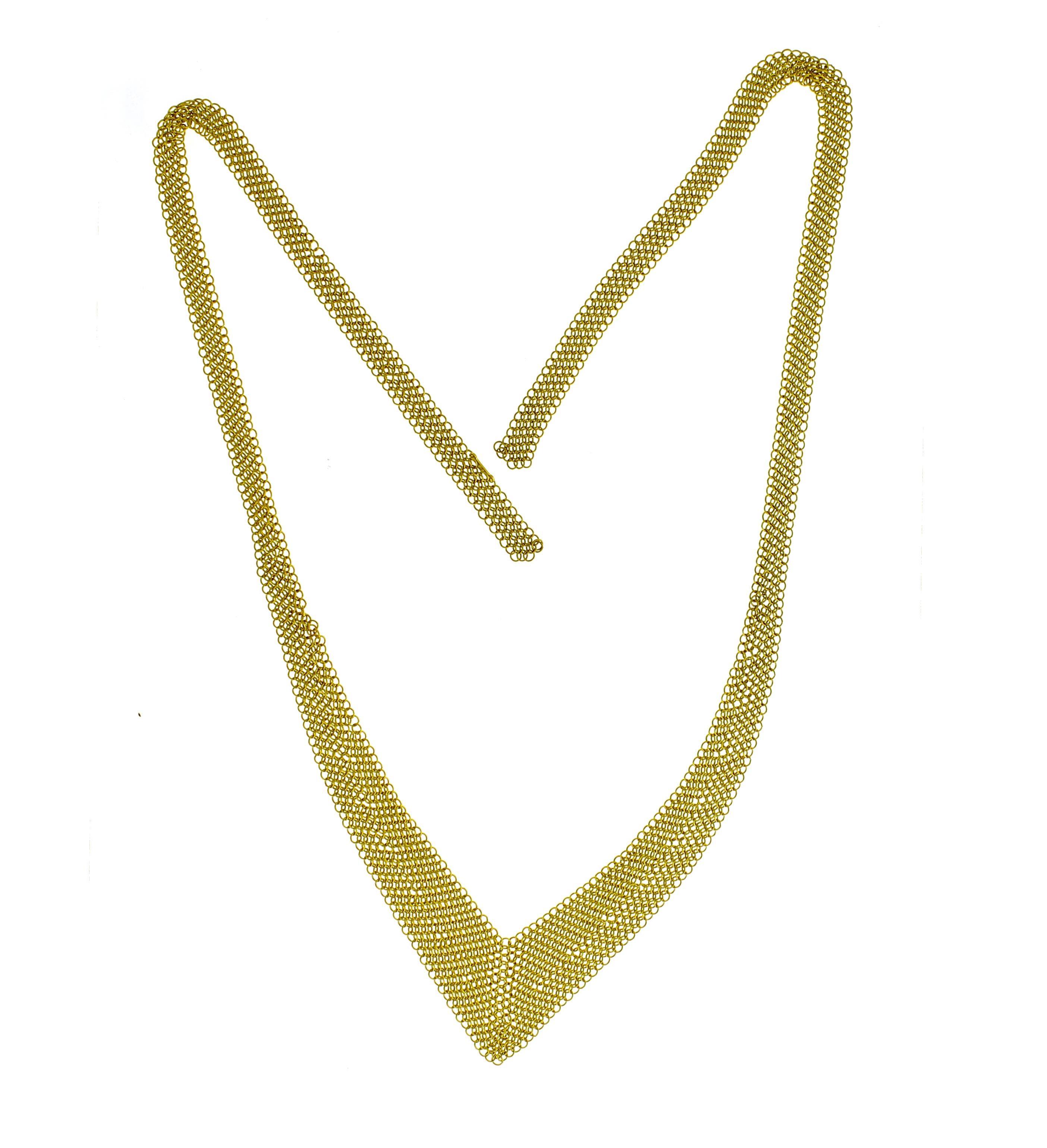 From Tiffany and Co.'s acclaimed designed Elsa Peretti, her 18 karat gold mesh neck scarf.  The necklace measures 25½ inches in length and graduates in from ¼ inch to 1 inch. 31.5 grams