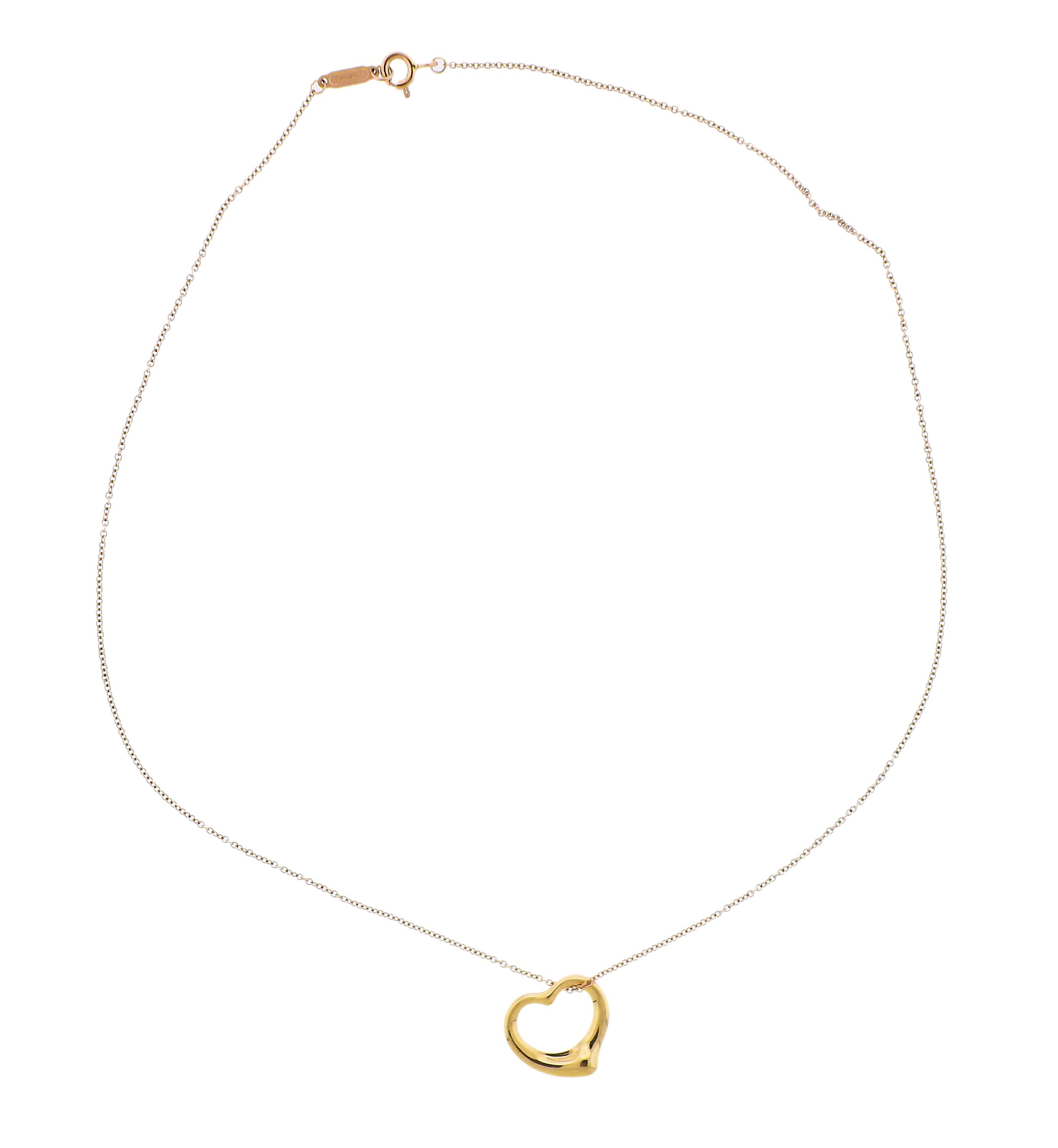 18k gold Open Heart pendant, suspended on a chain. Pendant designed by Elsa Peretti for Tiffany & Co. Necklace is 16