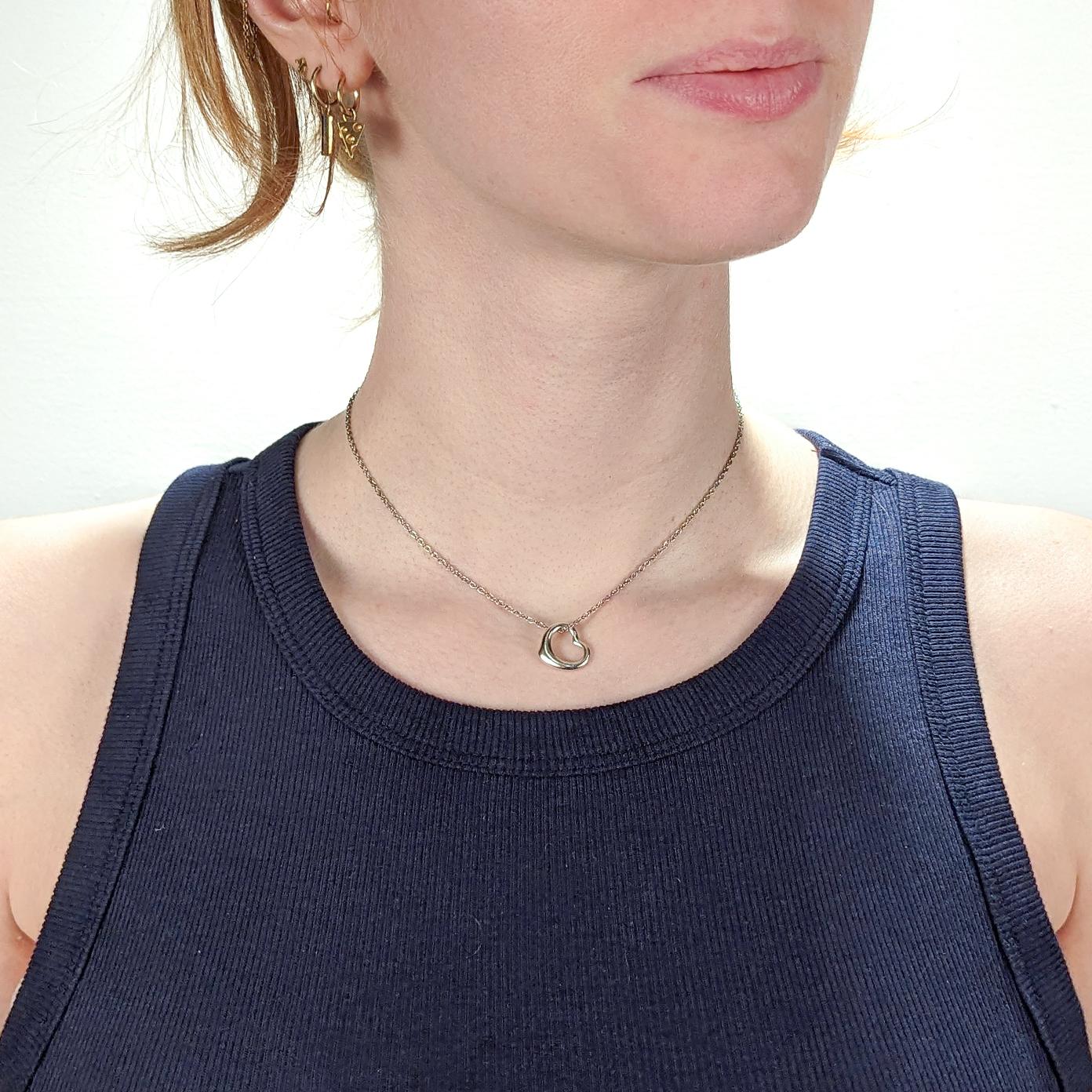 A fine Open Heart pendant or charm for a necklace.

In sterling silver.

Designed by Elsa Peretti for Tiffany & Co.

From her Open Heart series.

Marked to the reverse of the pendant for Tiffany & Co. / Elsa Peretti / 925 / Spain.

Together with an