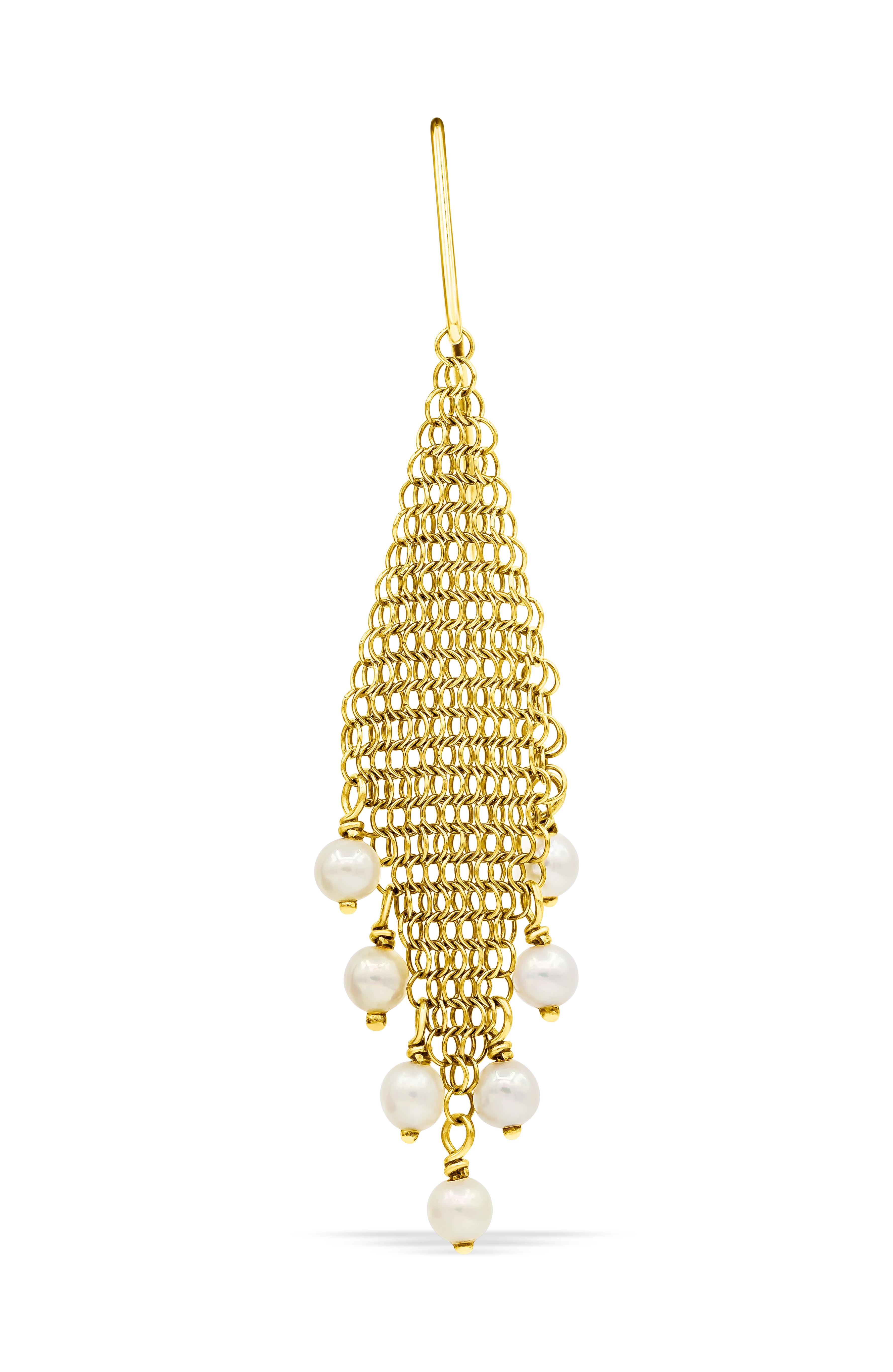 A gorgeous pari of 18 karat gold earrings designed by Elsa Peretti for Tiffany & Co. Features freshwater cultured peals fringing from golden mesh. 

