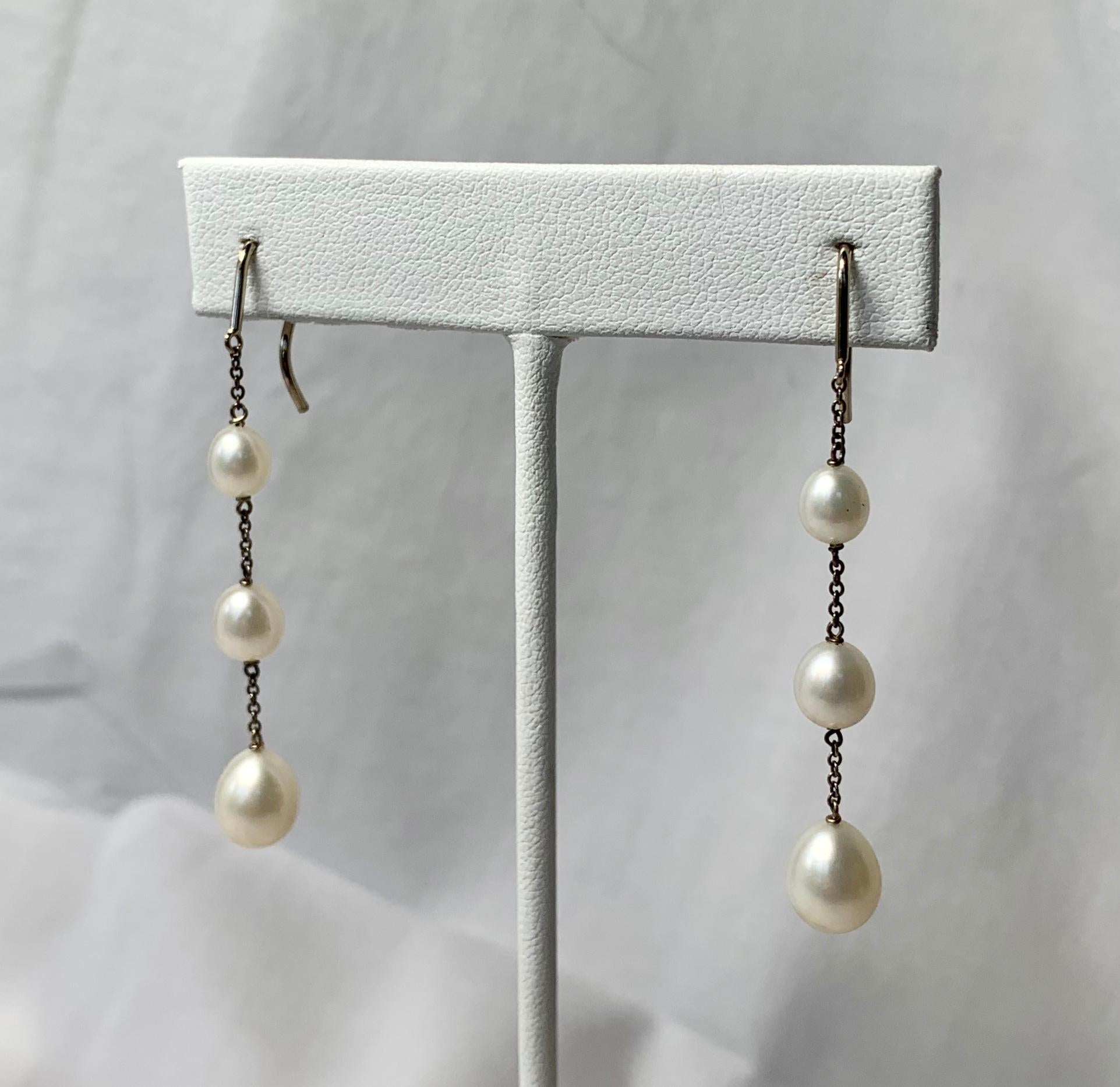 Gorgeous Tiffany & Co. Elsa Peretti Pearls by the Yard Chain Earrings.  Floating on a delicate Sterling Silver chain, Pearls are sleek treasures harboring luminescence in their round profiles.  The earrings are Sterling silver with six freshwater