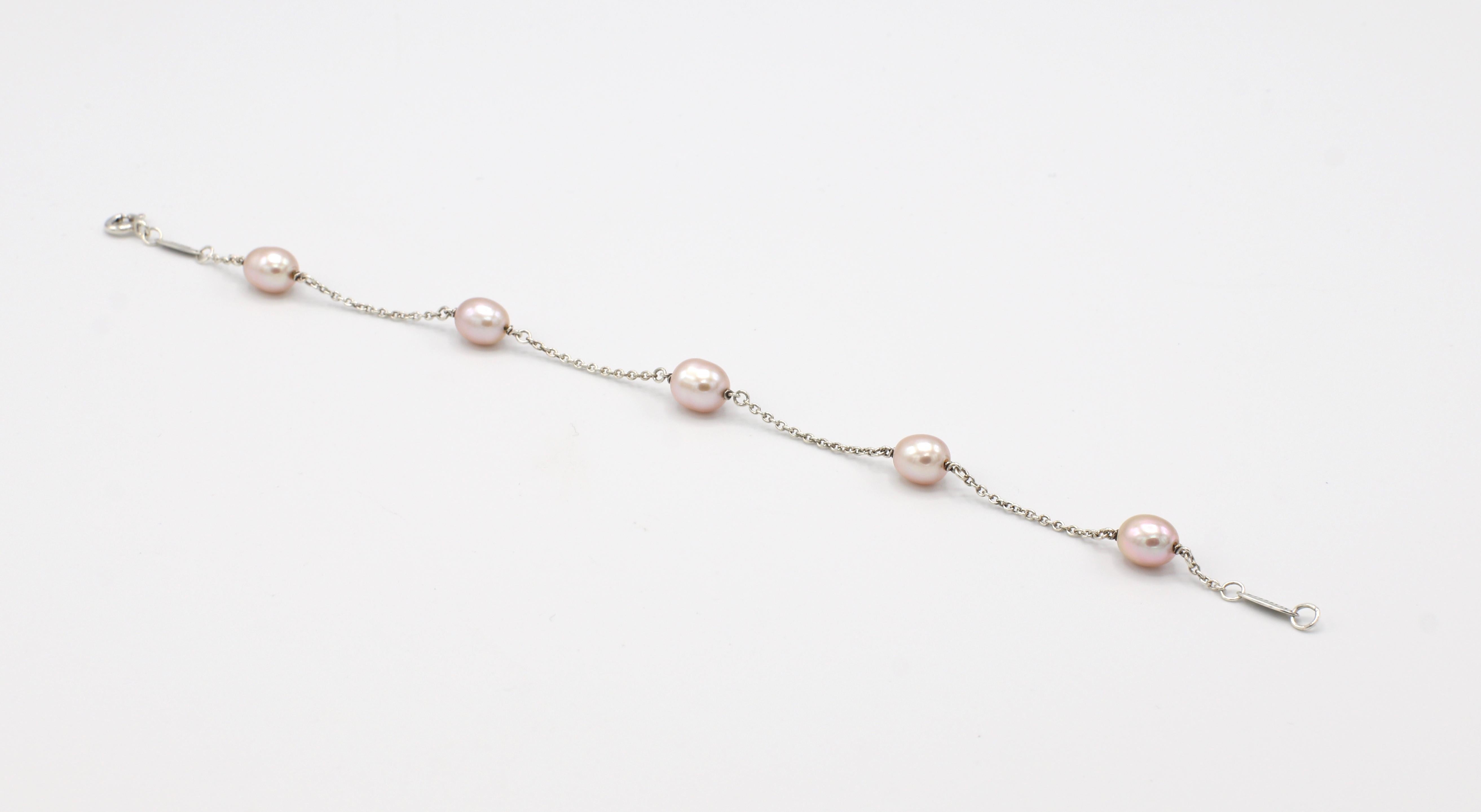 Tiffany & Co. Elsa Peretti Pearls By The Yard Sterling Silver Freshwater Cultured 5 Pearl Station Bracelet

Metal: Sterling Silver
Weight: 3.48 grams
Length: 7.25 inches 
Pearls: Approx. 6.5mm, pinkish white hue 
Signed: 