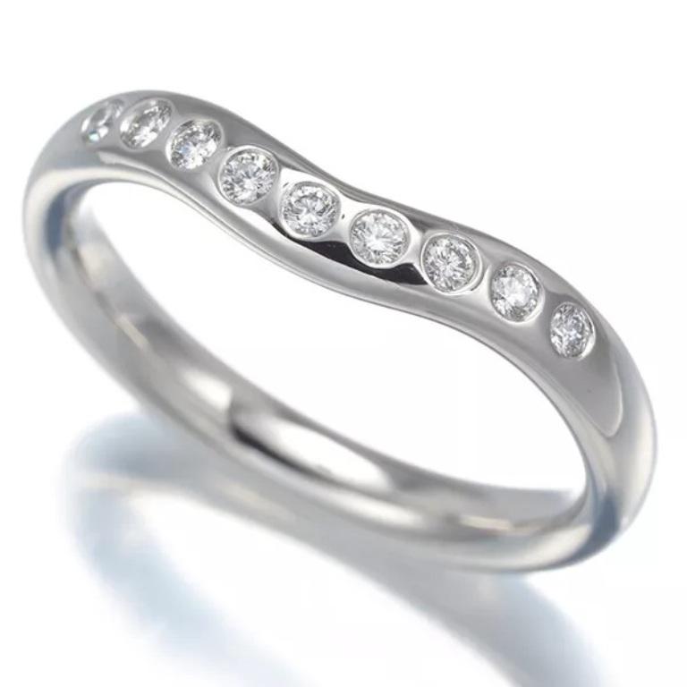 TIFFANY & Co. Elsa Peretti Platinum .10ct Diamond 3mm Curved Band Ring 5.5

Metal: Platinum
Size: 5.5
Weight: 5.30 grams
Band Width: 3mm
Diamond: 9 round brilliant diamonds, carat total weight .10 
Hallmark: ©PERETTI SPAIN TIFFANY&CO.