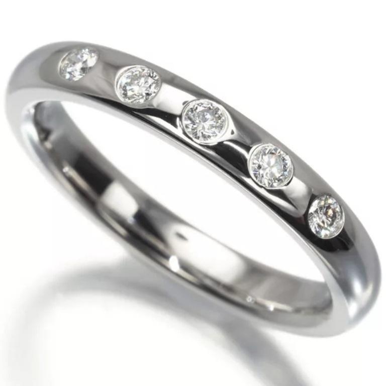 TIFFANY & Co. Elsa Peretti Platinum .10ct Diamond Stacking Band Ring 5

 Metal: Platinum
 Size: 5 
 Band Width: 2.7mm
 Weight: 5.30 grams 
 Diamond: 5 round brilliant diamonds, carat total weight .10 
 Hallmark: T&Co. ©PERETTI PT950 SPAIN 
