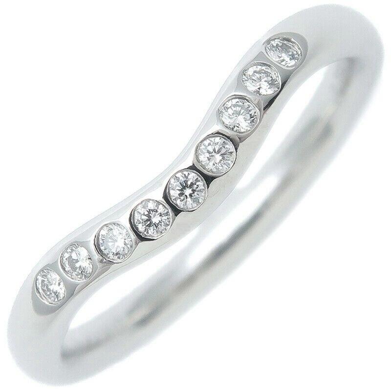 TIFFANY & Co. Elsa Peretti Platinum Diamond 2mm Curved Wedding Band Ring 4

Metal: Platinum
Size: 4
Weight: 3.10 grams
Band Width: 2mm
Diamond: 9 round brilliant diamonds, carat total weight .06 
Hallmark: ©PERETTI SPAIN TIFFANY&CO. PT950
Condition: