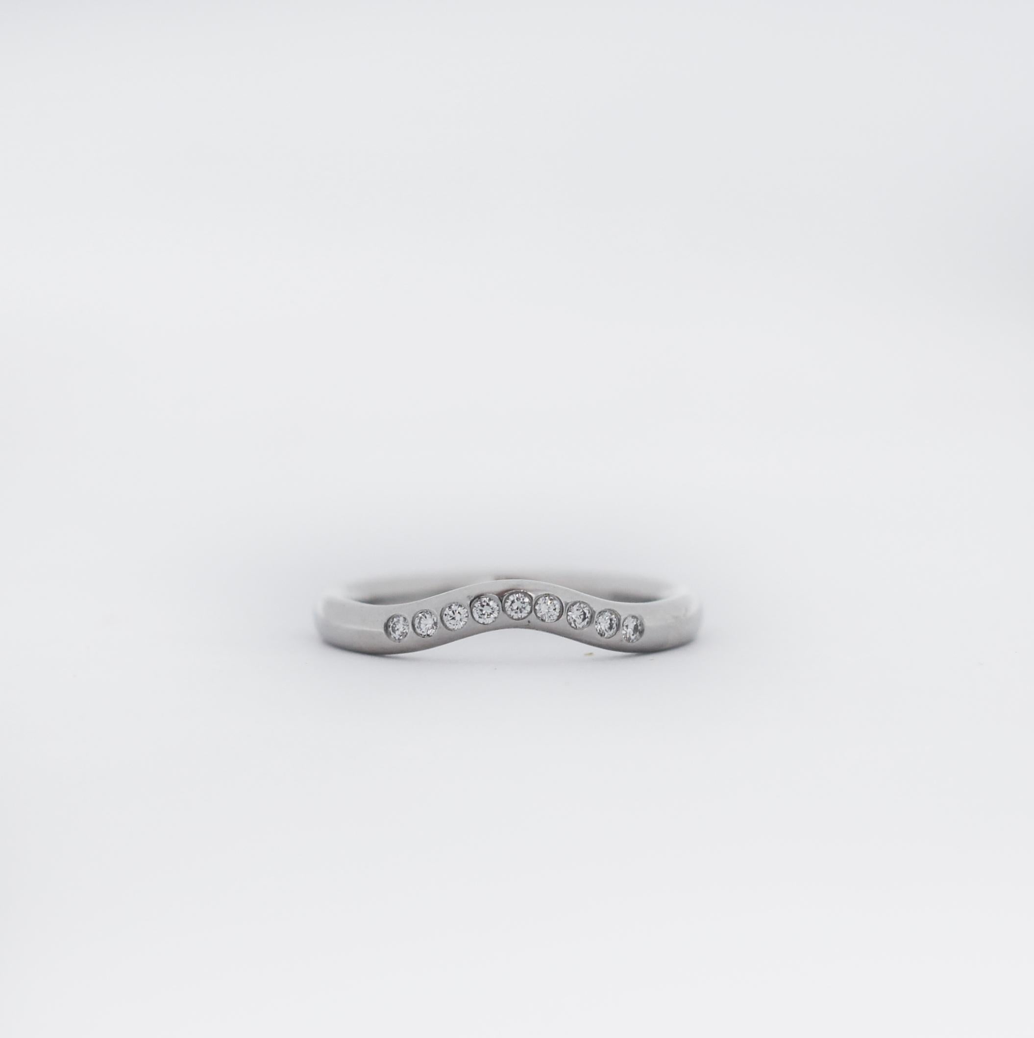 TIFFANY & CO.
Description & Details
Round brilliant diamonds add sparkle to Peretti's sculptural design.
Curved wedding band ring with diamonds in platinum.
Original designs copyrighted by Elsa Peretti.
Ring Size: 4.5
Weight: 3.5 grams
This