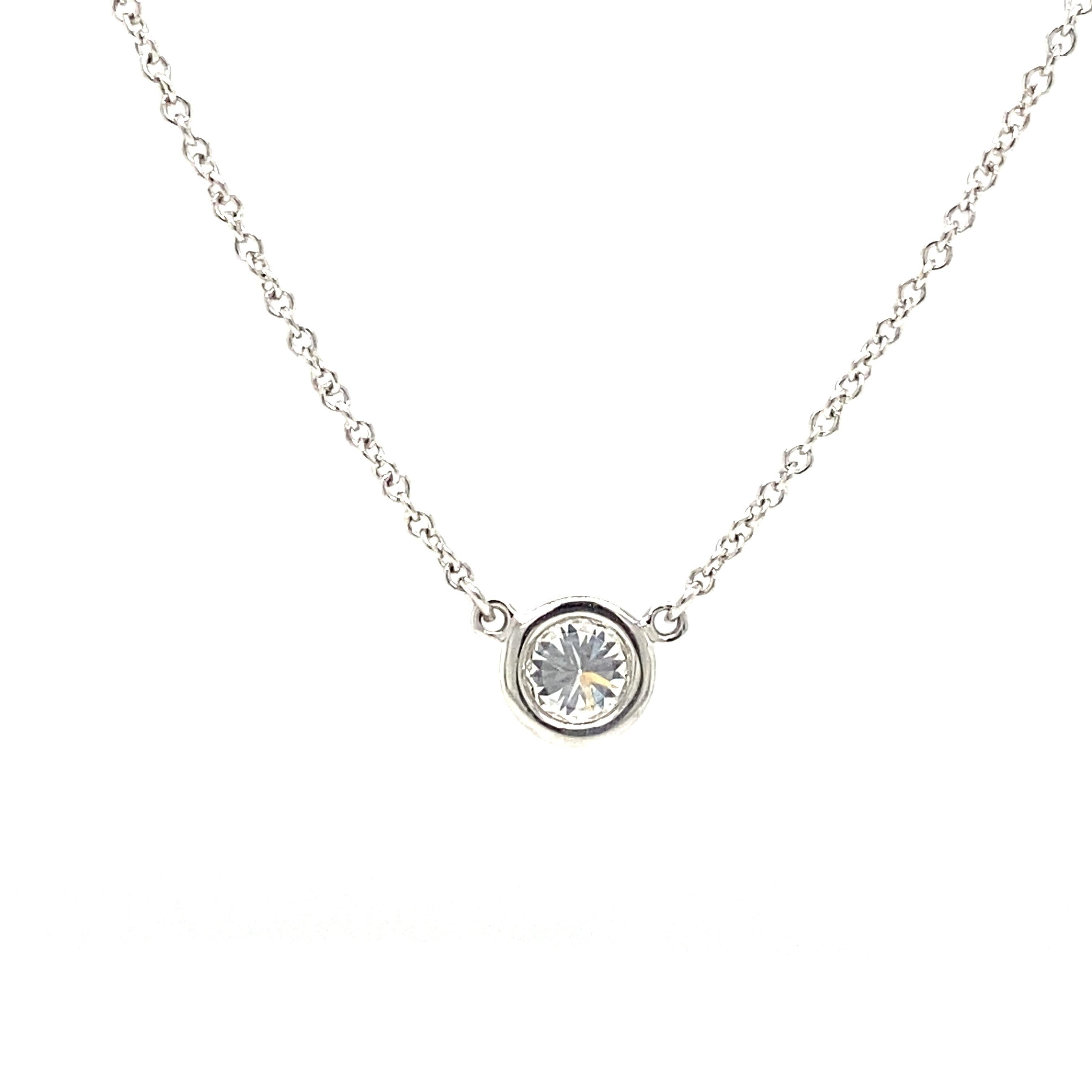 Tiffany & Co. Elsa Peretti Diamond Solitaire Pendant Necklace in Platinum.  (1) Round Brilliant Cut Diamonds weighing 0.33 carat total weight, F in color and VS1 in clarity is expertly bezel set.  The Necklace measures 16 inch in length.  Signed. 