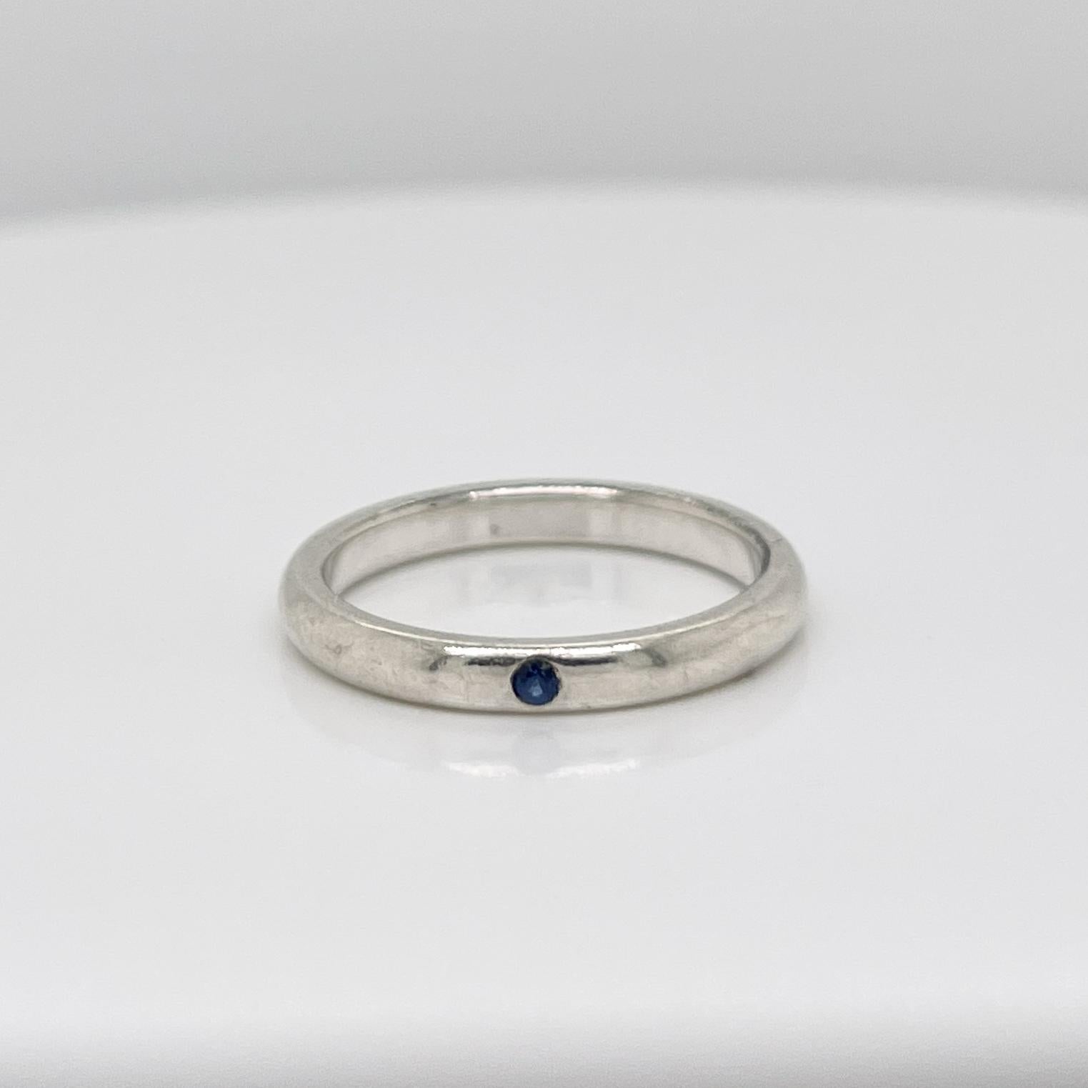 A very fine Tiffany & Co. sterling silver ring.	

By Elsa Peretti. 

Flush set with a round cut sapphire.

Perfect, Simple, Refined.

Date:
20th Century

Overall Condition:
It is in overall good, as-pictured, used estate condition with some very