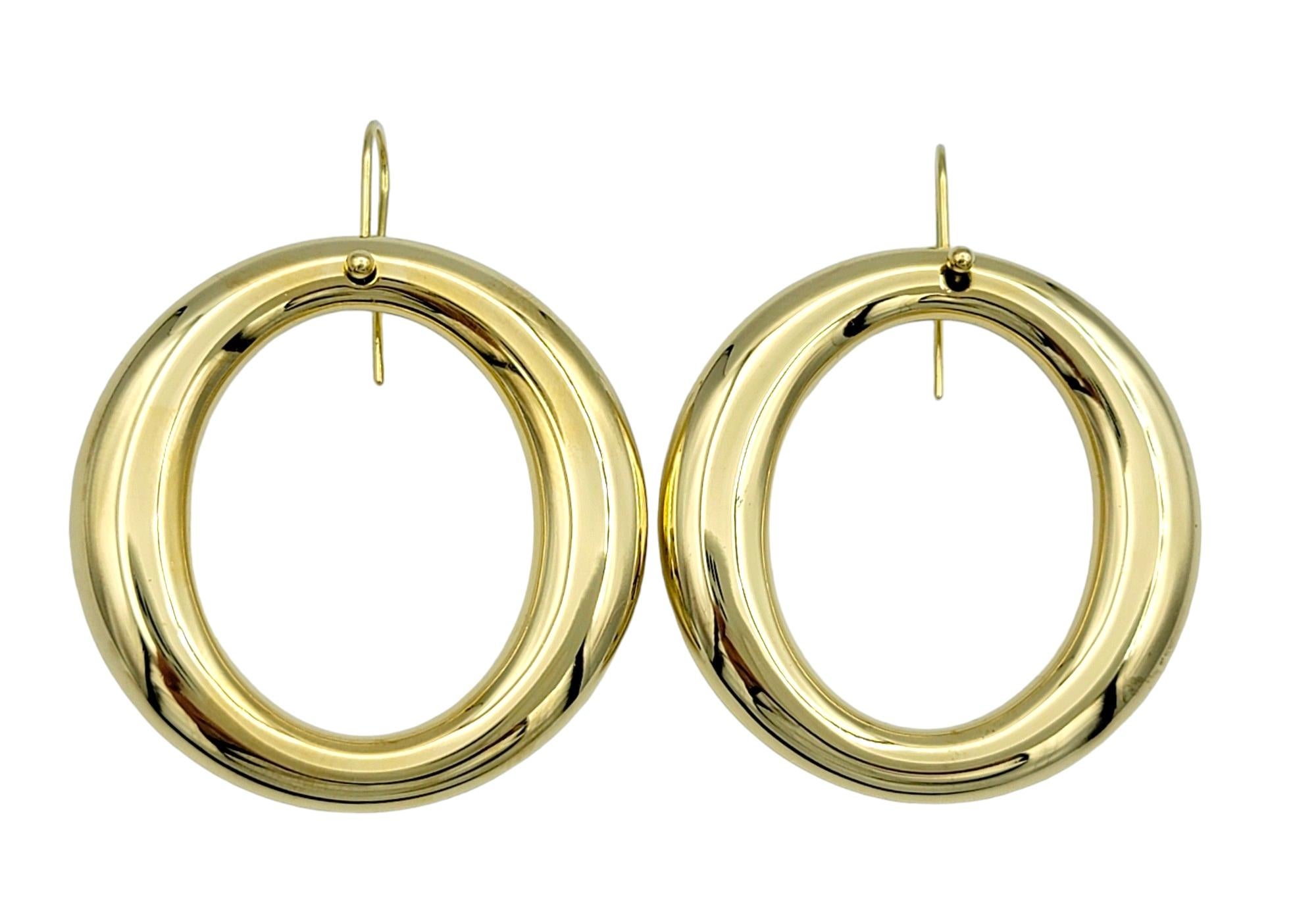 These elegant earrings from Tiffany & Co.'s Elsa Peretti Sevillana collection feature a timeless open circle design, and set in lustrous 18 karat yellow gold. The simplicity of the design is elevated by the luxuriousness of the gold, creating a