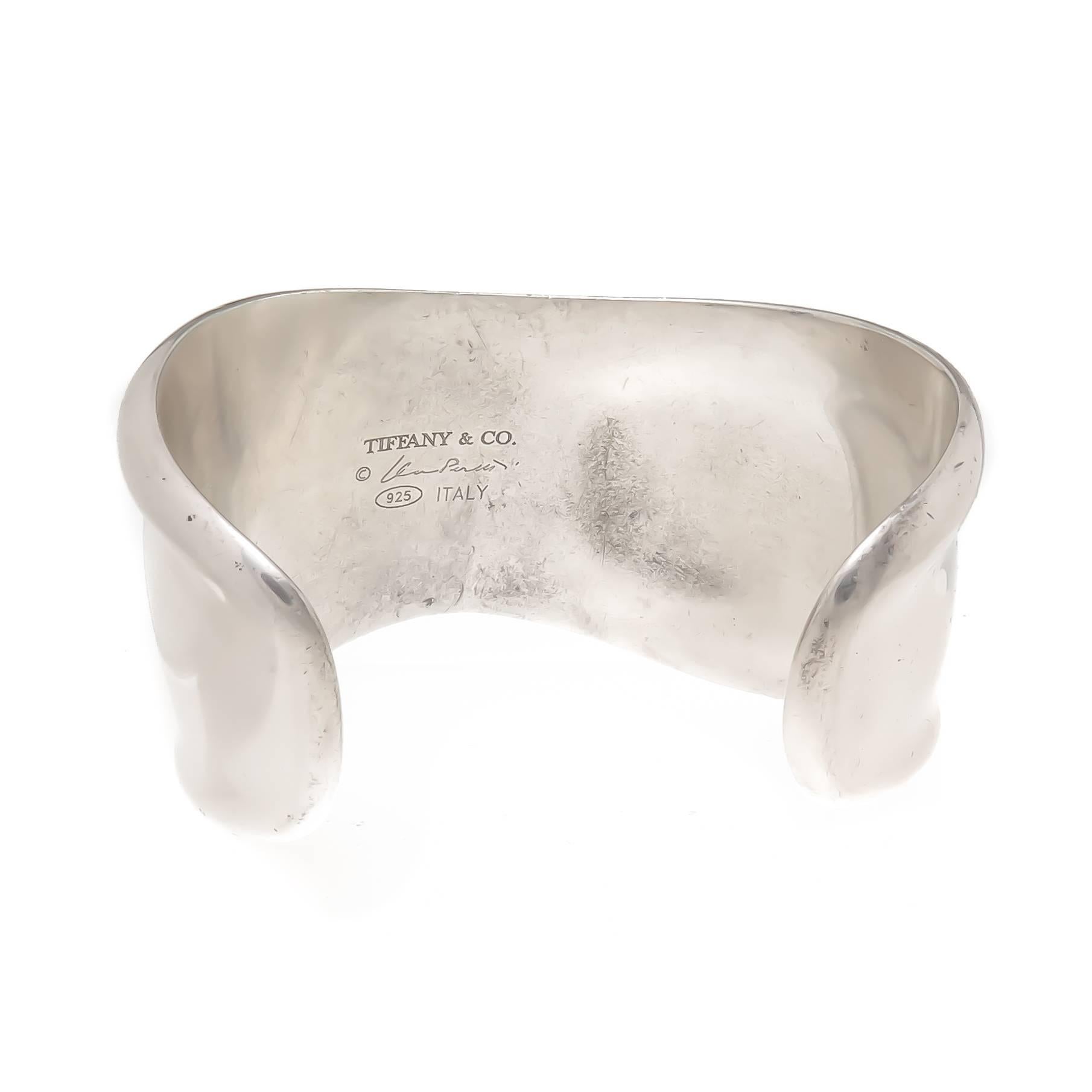 Circa 2000 Elsa Peretti for Tiffany & Co., Sterling Silver Bone Cuff Bracelet. Measuring 1 1/2 inch at its widest point, an opening of 1 1/8 inch and an inside measurement of approximately 6 1/8 inch. This is the medium size bracelet from the Bone