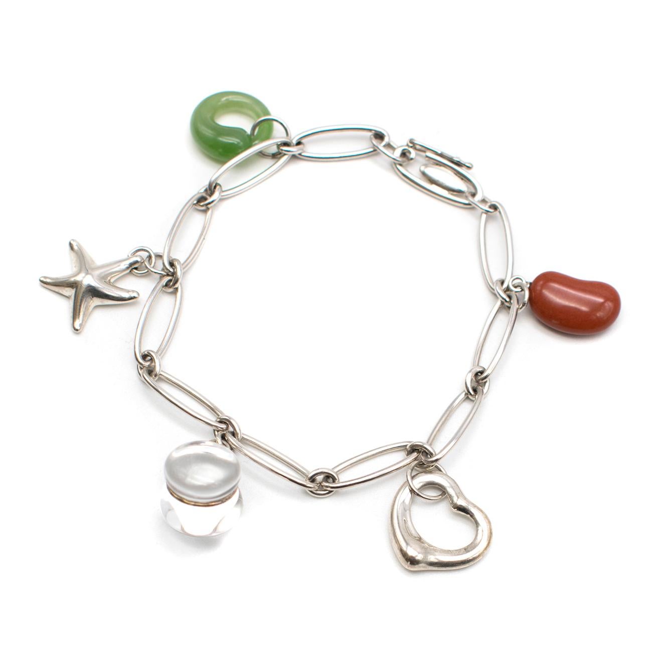 Tiffany & Co. Elsa Peretti Silver Five-Charm Bracelet

- Charm bracelet in sterling silver
- Red jasper Bean
- Sterling silver Open Heart 
- Rock crystal Toy
- Sterling silver Starfish 
- Green jade Eternal Circle. 

Please note, these items are