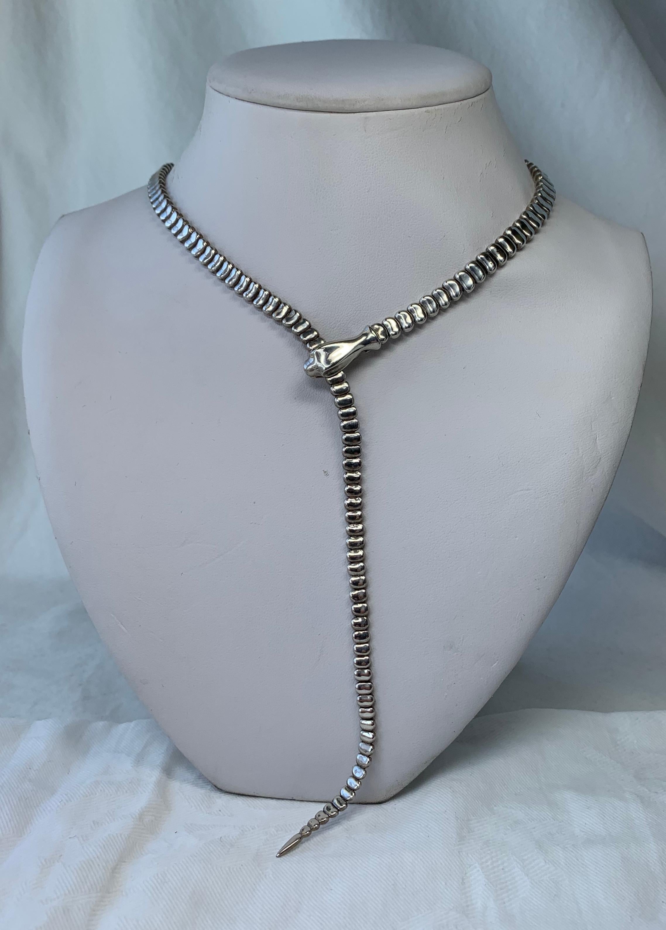 This incredible and rare Vintage (circa 1980s) serpentine snake necklace from Tiffany & Co. is one of Elsa Peretti's iconic snake designs! The necklace was originally designed by Peretti in the 1970's to accessorize the designs of Halston. Crafted