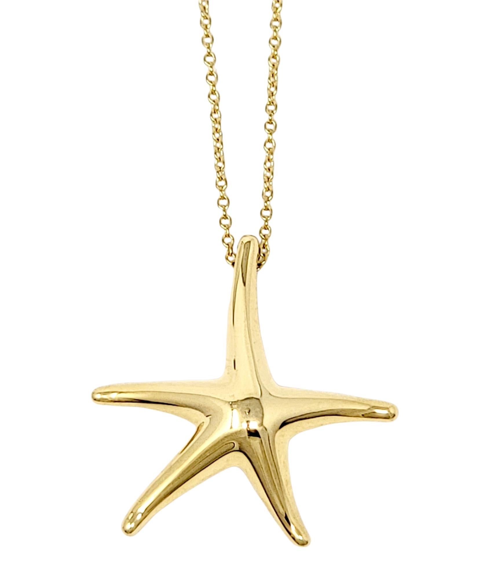 Calling all ocean lovers! This charming starfish pendant necklace designed by Elsa Peretti for Tiffany & Co. will remind you of a dazzling day out at the sea. The modernized starfish motif is secured to a fine cable link chain that gently hugs the