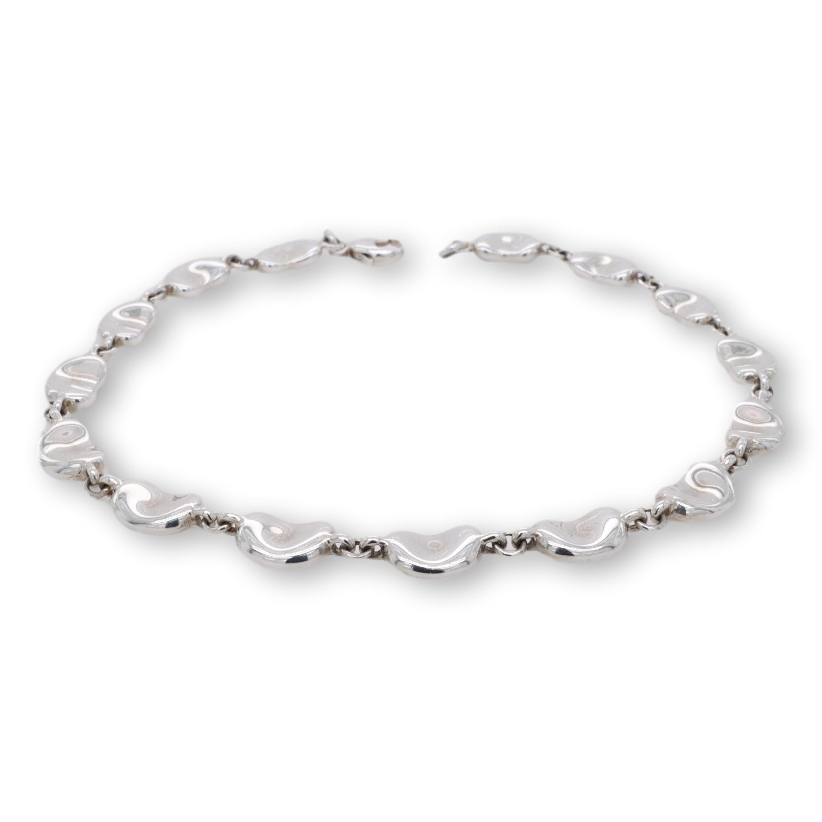 Tiffany & Co. bracelet designed by Elsa Peretti from the bean collection finely crafted in sterling silver featuring 15 bean motifs with lobster claw closure. Fully hallmarked with logo and metal content.

Bracelet Specifications
Brand: Tiffany &