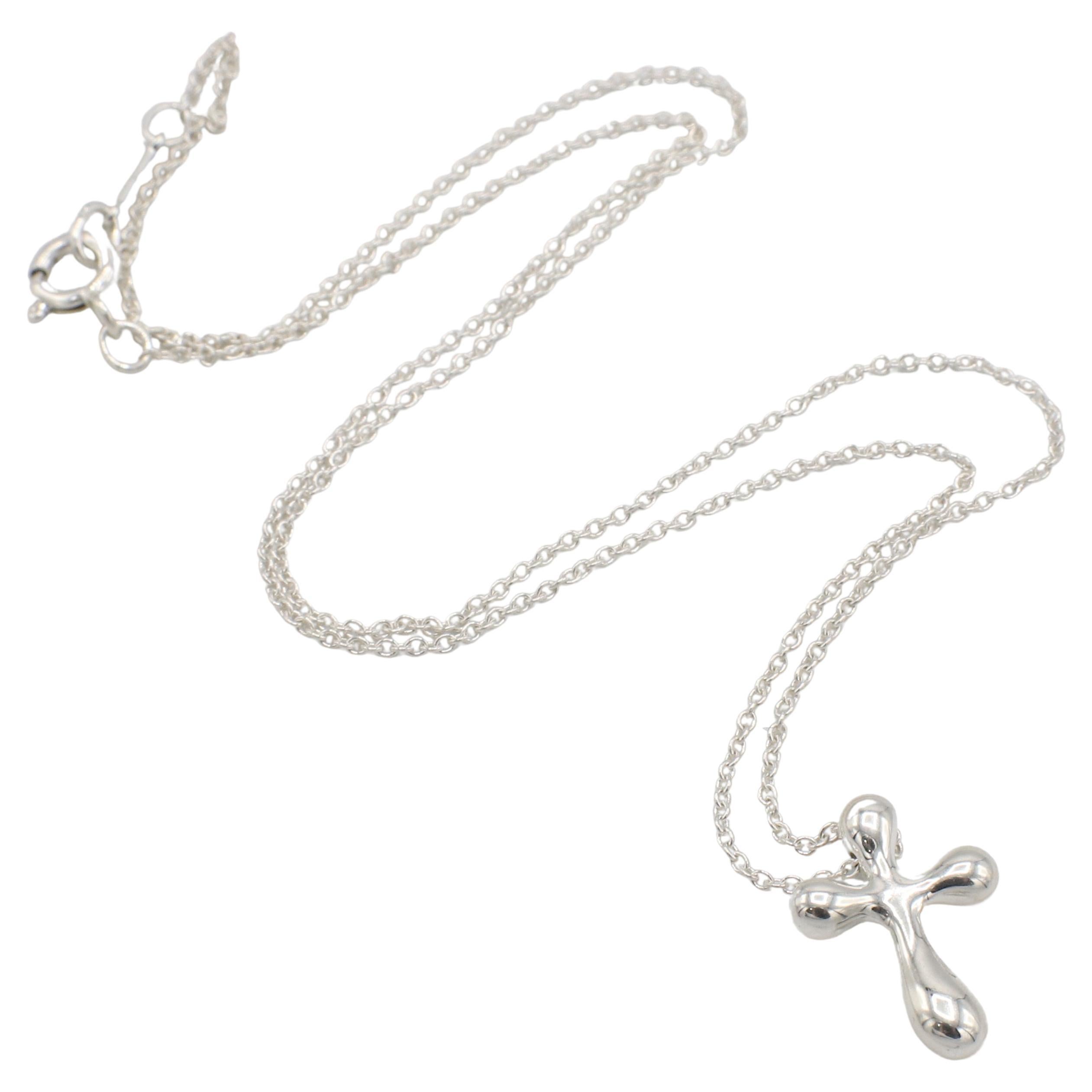 Tiffany & Co. Elsa Peretti Sterling Silver Cross Pendant Drop Necklace 
Metal: Sterling silver
Weight: 2.48 grams
Cross: 16 x 11.5mm 
Chain length: 16 inches
Signed: T&Co. 925 PERETTI