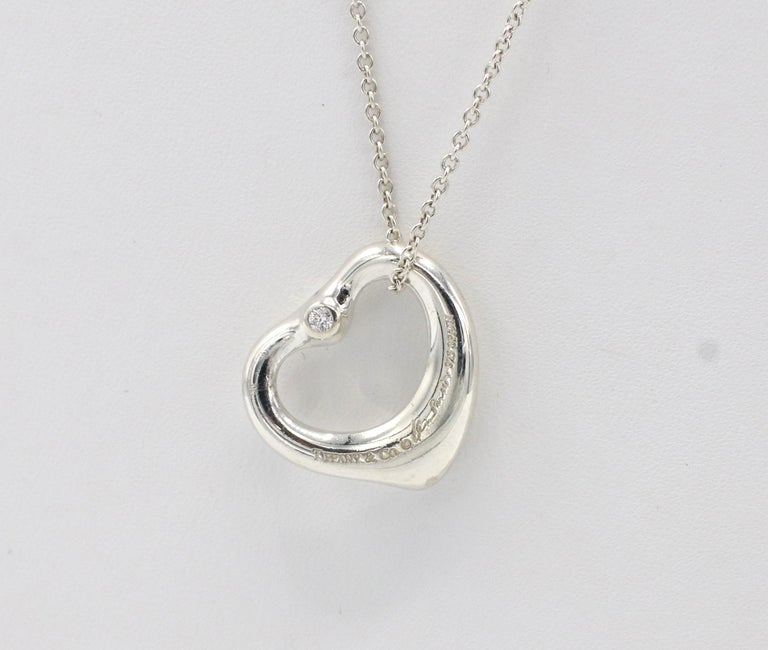 Tiffany & Co. Elsa Peretti Sterling Silver Diamond Open Heart Pendant Necklace
Metal: Sterling silver
Weight: 3.17 grams
Pendant: 15.5 x 13.5mm
Diamonds: 2 round diamonds approx. .04 CTW G VS
Chain: 18 inches
