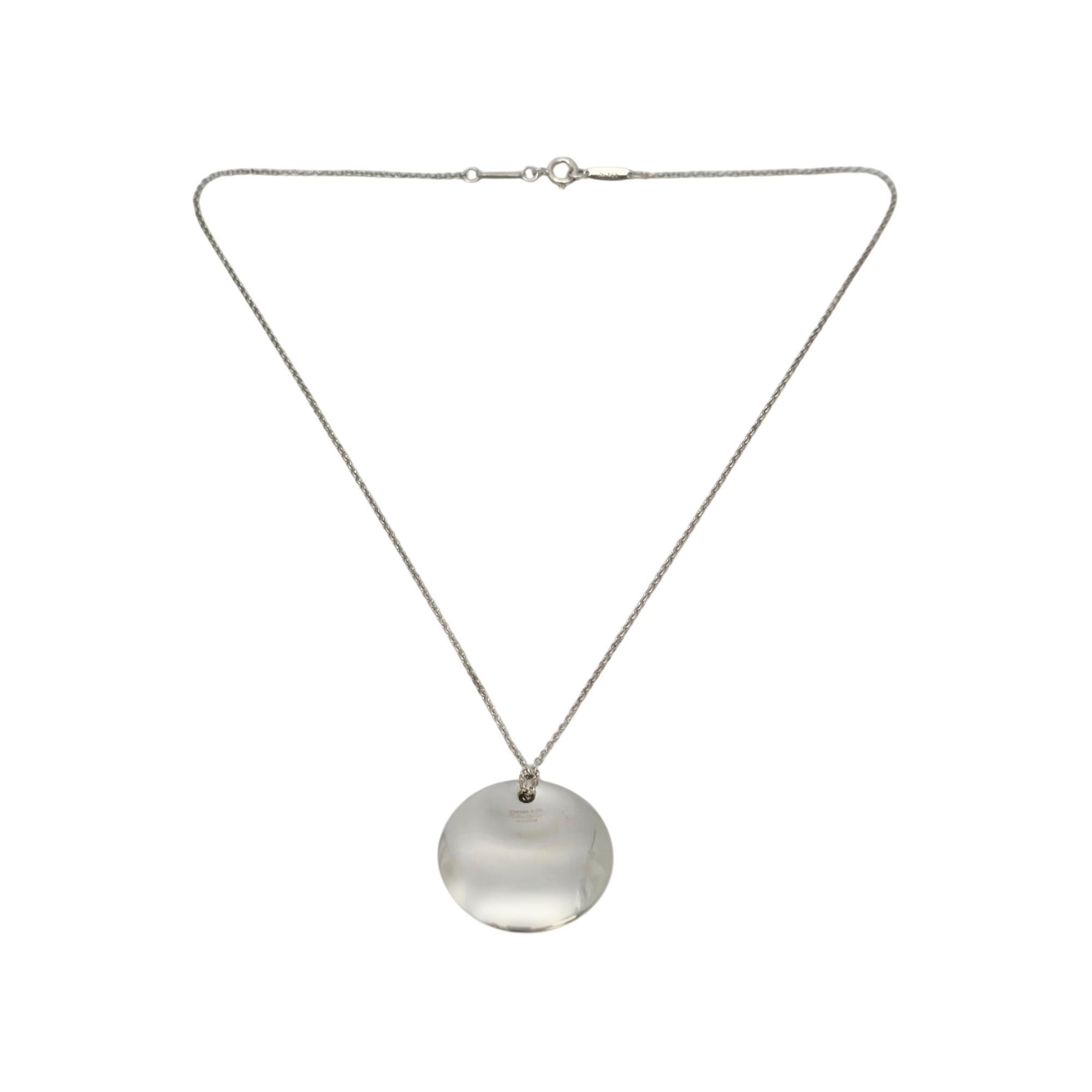 Sterling silver disc pendant with chain necklace by Elsa Peretti for Tiffany & Co.

This authentic Tiffany necklace features a disc design pendant on a delicate chain. Tiffany pouch and box are not included.

Chain measures approx 15