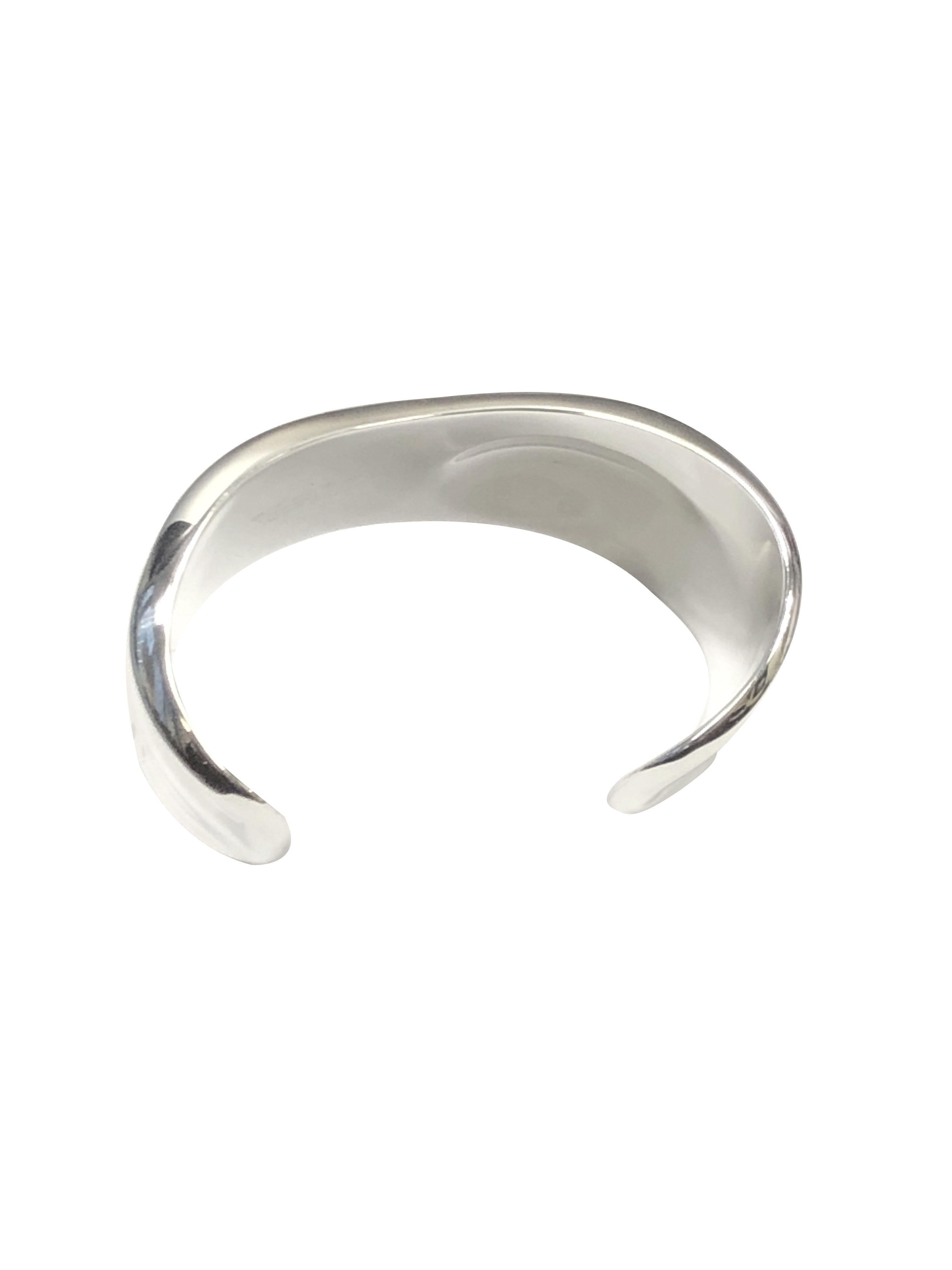 Circa 2000 Elsa Peretti for Tiffany & Co., Sterling Silver Medium Bone Cuff Bracelet. Measuring 1 1/2 inch at its widest point, an opening of 1 1/8 inch and an inside measurement of approximately 6 1/8 inch. Comes in a Tiffany dust / travel pouch.