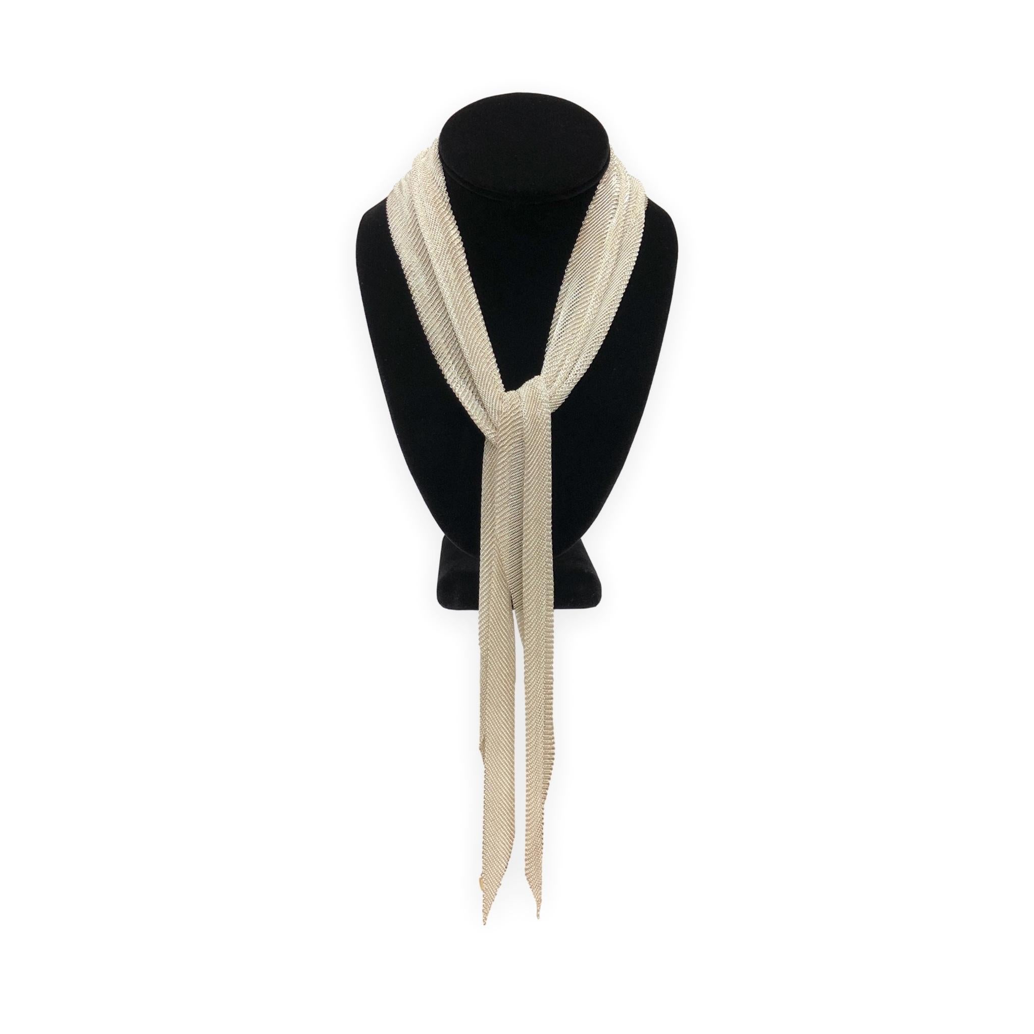 This is the large-format Elsa Peretti mesh tie scarf, crafted in ultra-fine sterling silver mesh. The construction is extremely delicate and flexible, giving it a silky, fabric-like feel that moves and drapes like actual cloth. At 41.5 inches, this