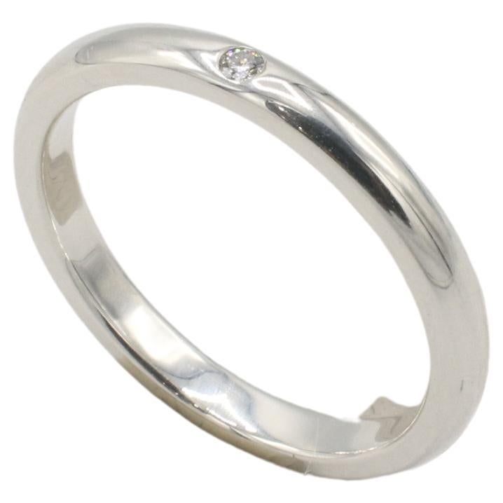 Tiffany & Co. Bague en argent Elsa Peretti avec incrustation de diamants naturels 
Métal : Argent sterling 925
Poids : 2.71 grammes
Diamant : 1 diamant rond naturel d'environ 0,03 carat F VVS
Taille : 7.5 (US)
Largeur : 2.5mm
Signé : Tiffany & Co.