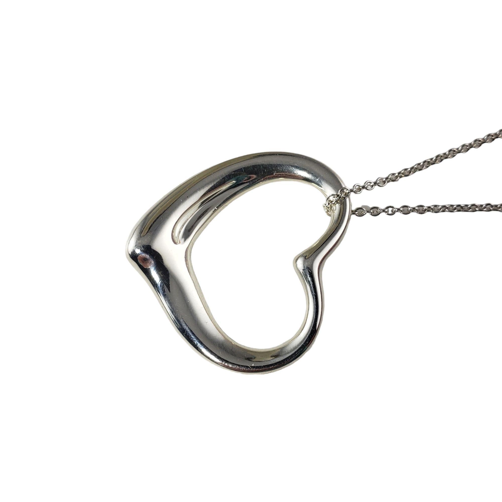 Vintage Tiffany & Co. Elsa Peretti Sterling Silver Open Heart Pendant Necklace-

This elegant open heart pendant by Elsa Peretti for Tiffany & Co. suspends from a classic cable necklace.

Size: 30 inches (necklace)
35 mm (pendant)

Weight: 16 gr./