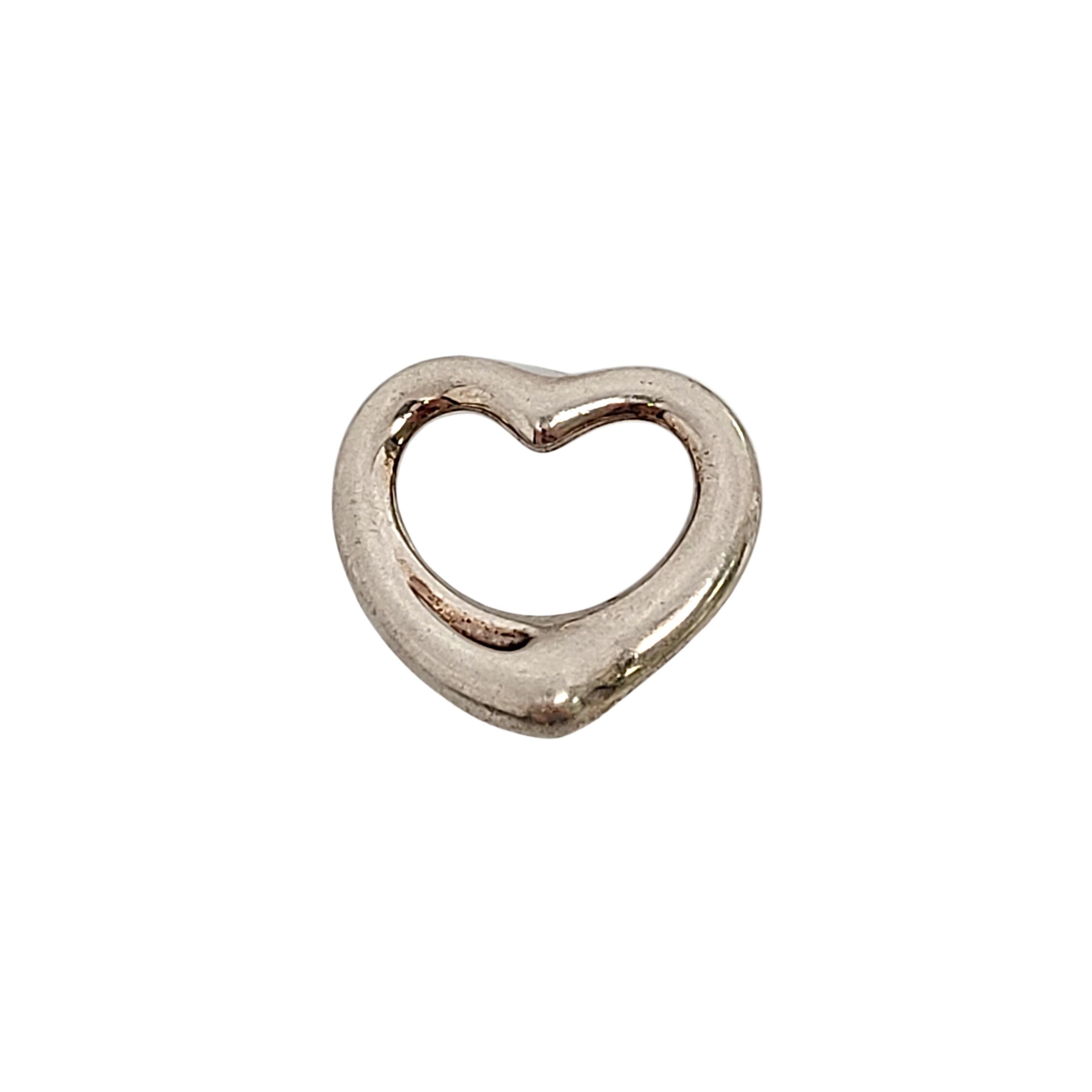 Tiffany & Co sterling silver Open Heart pendant by Elsa Peretti.

An authentic Tiffany & Co sterling silver pendant in Elsa Peretti's timeless signature open heart design. Tiffany pouch and box not included.

Measures approx 3/4