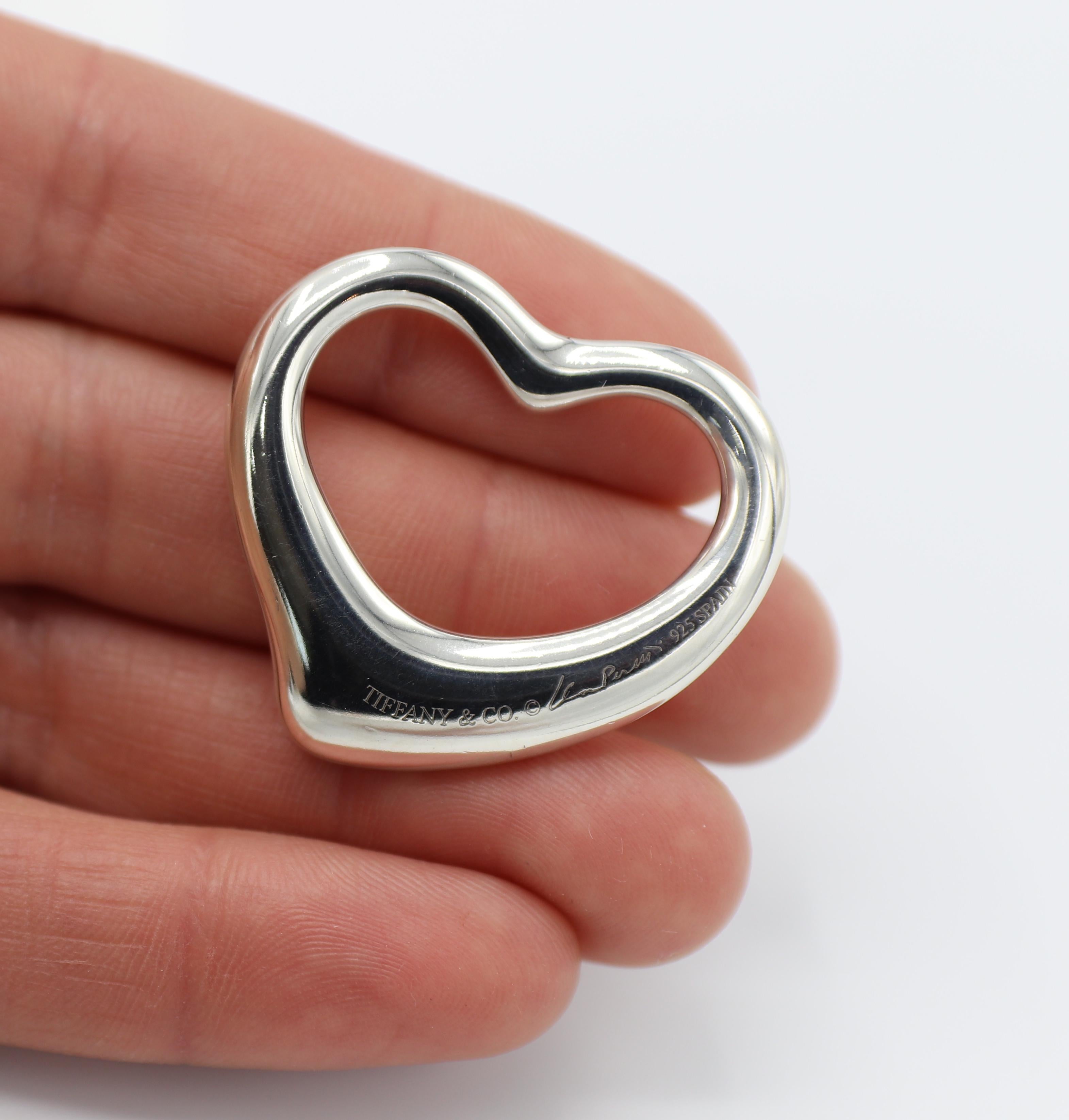 Tiffany & Co. Elsa Peretti Sterling Silver Open Heart Pendant 
Metal: Sterling silver 925
Dimensions: 34.5 x 32mm
Weight: 15.55 grams
Note: Pendant only (no chain)
