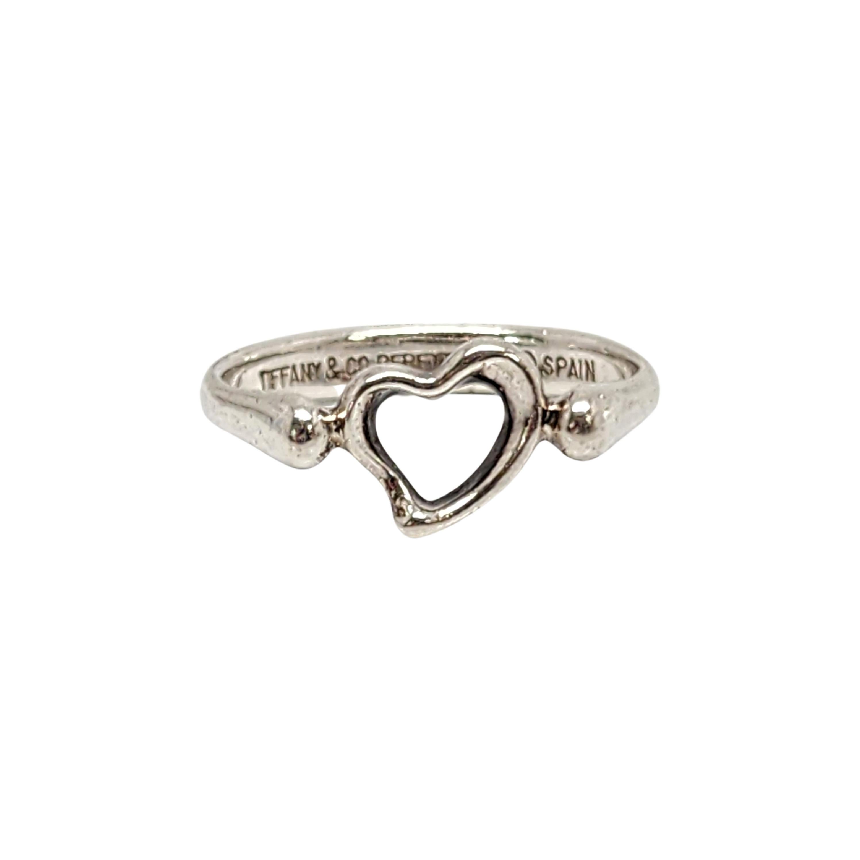 Tiffany & Co sterling silver Open Heart ring designed by Elsa Peretti.

Size 4 1/2

Authentic Tiffany ring featuring Elsa Peretti's signature open heart design. Tiffany pouch and box are not included.

Measures approx 3/8