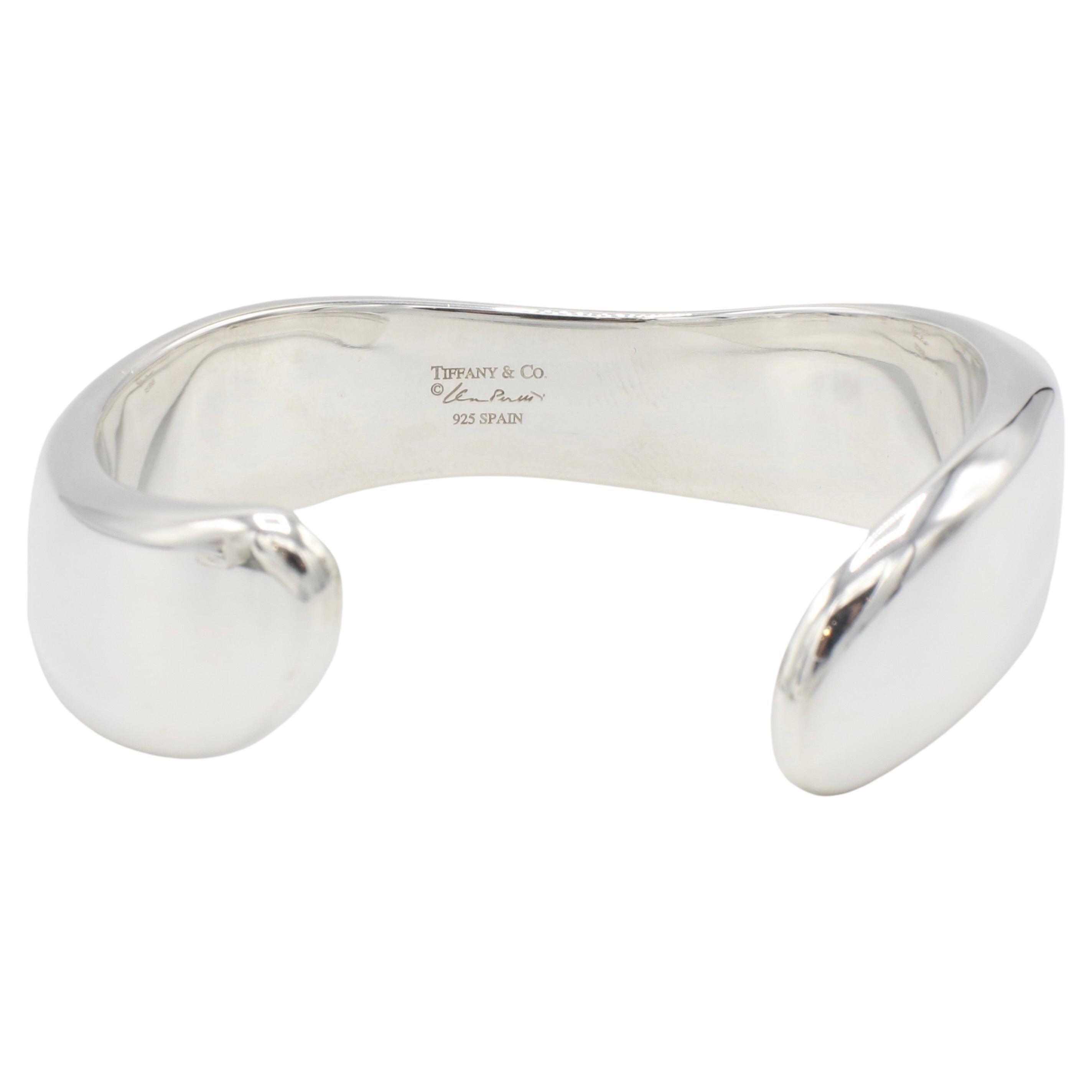 Tiffany & Co. Elsa Peretti Sterling Silver Swirl Cuff Bracelet
Metal: Sterling silver 925
Weight: 35.5 grams
Retail: $1,500 USD
Width: 17mm
Length: 6.5 inche wrist
Signed: Tiffany & Co. ©Elsa Peretti SPAIN 925


