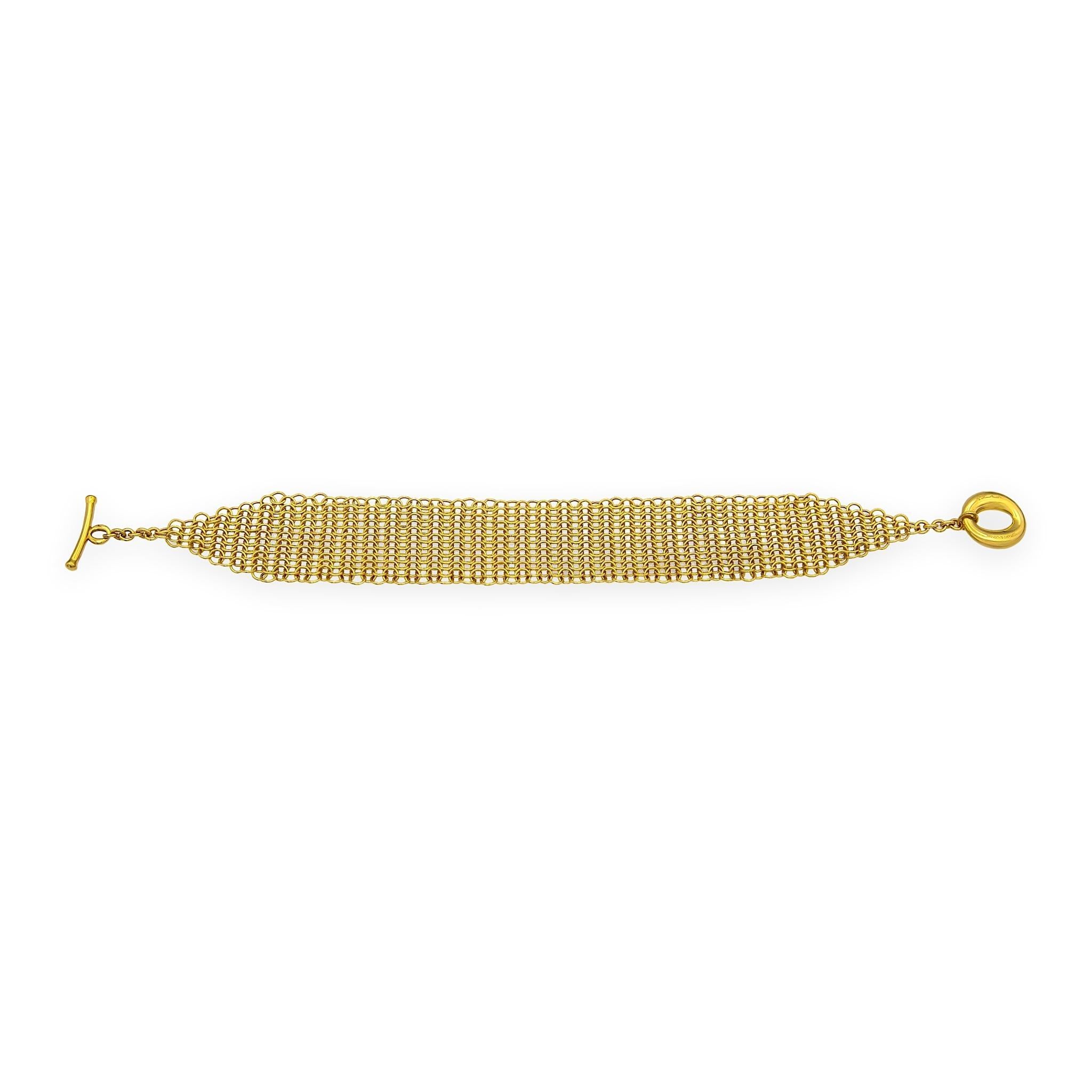 A Vintage Elsa Peretti mesh bracelet in 18K yellow gold, designed with her signature fluid drape and textile-like movement, and recognizable toggle closure. The bracelet molds comfortably to the wrist with soft flex and has strong presence at 31.7