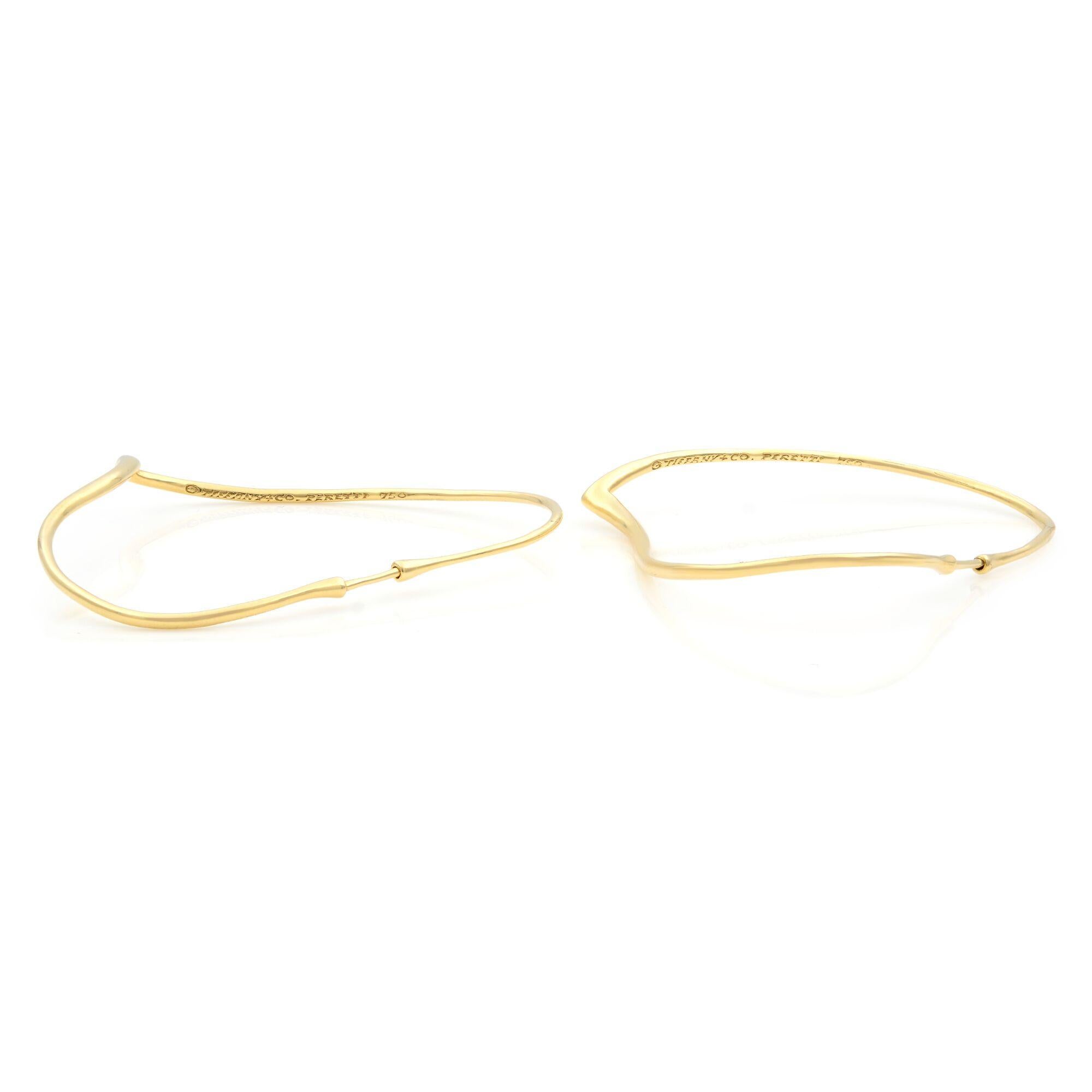 The Tiffany & Co simple shape of Elsa Peretti Open Heart design celebrates the spirit of love. These large hoop earrings are crafted in 18K yellow gold. Each earring measures 2.5 inches. Excellent pre-owned condition, Tiffany box is included. 
