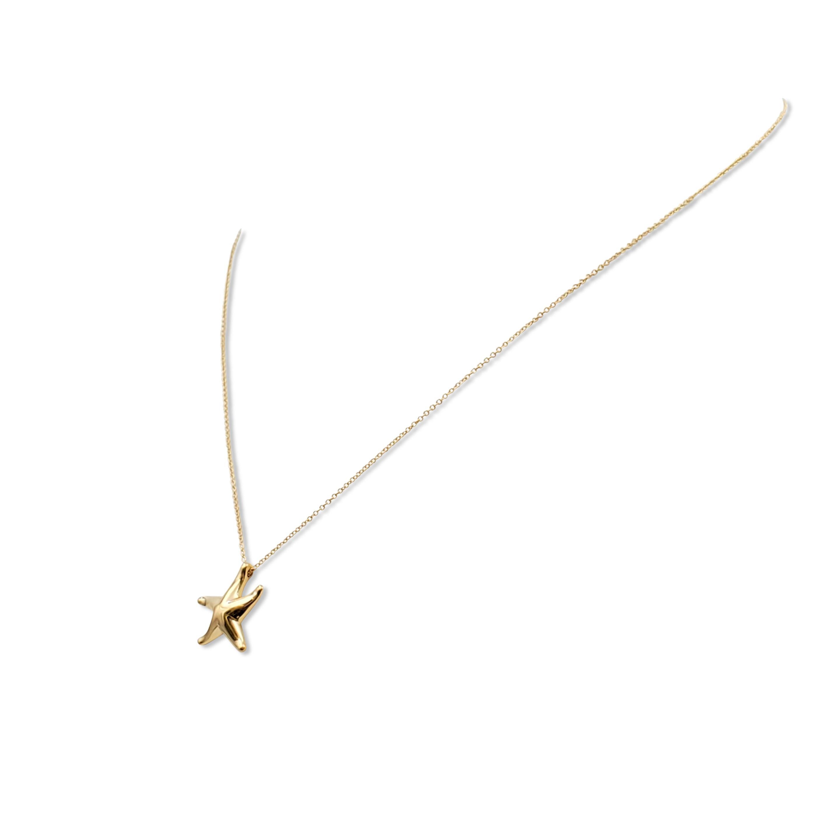 Authentic Elsa Peretti for Tiffany & Co. starfish pendant crafted in 18 karat yellow gold which hangs from a delicate Tiffany & Co. chain. Signed Tiffany & Co., Peretti,  750, Spain. The chain measures 16 inches in length. Not presented with the