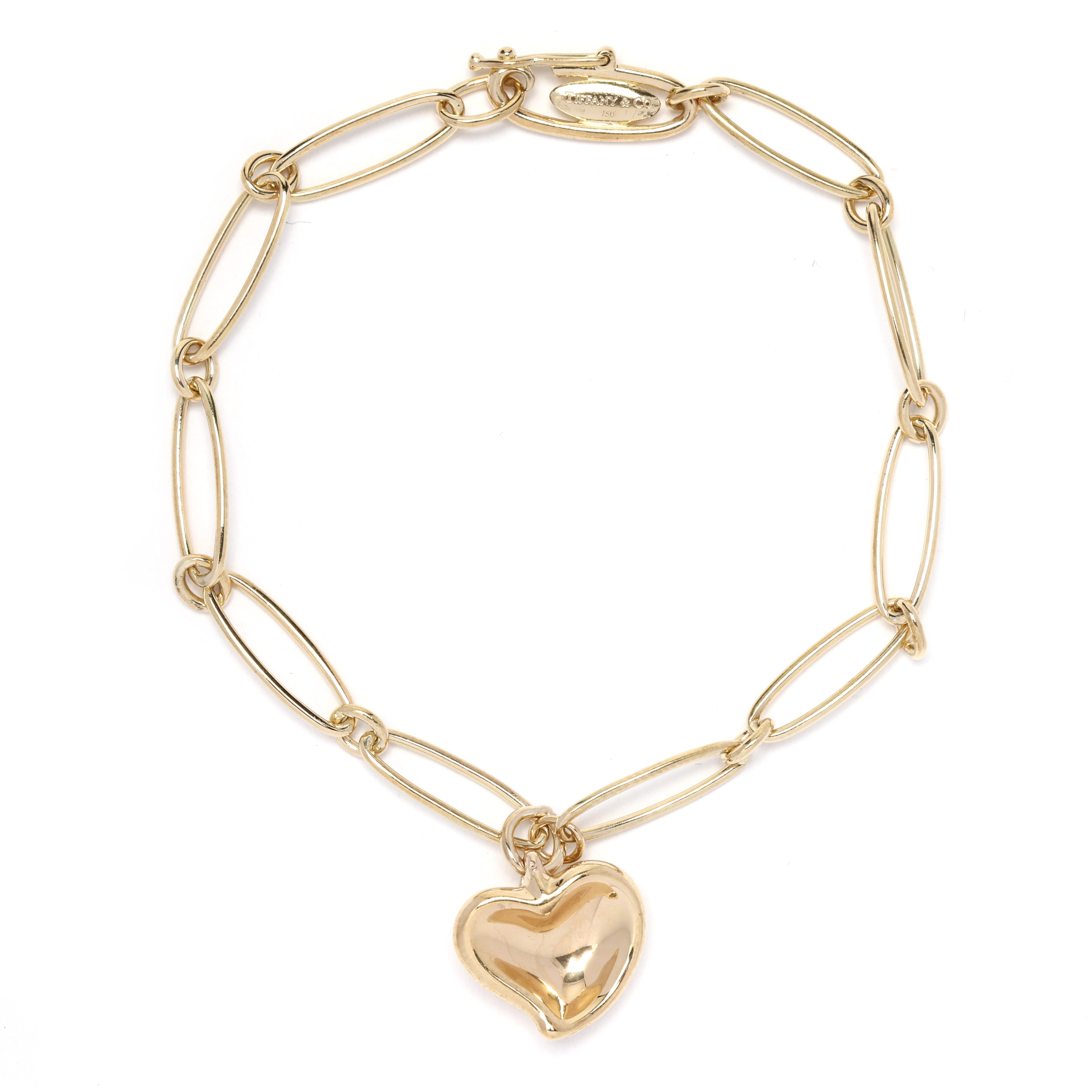 This Tiffany & Co. Elsa Perreti Link Bracelet is crafted in 18k yellow gold and features a delicate heart pendant. The bracelet measures 7.5 inches in length, making it the perfect size for everyday wear. The Elsa Perreti design is known for its