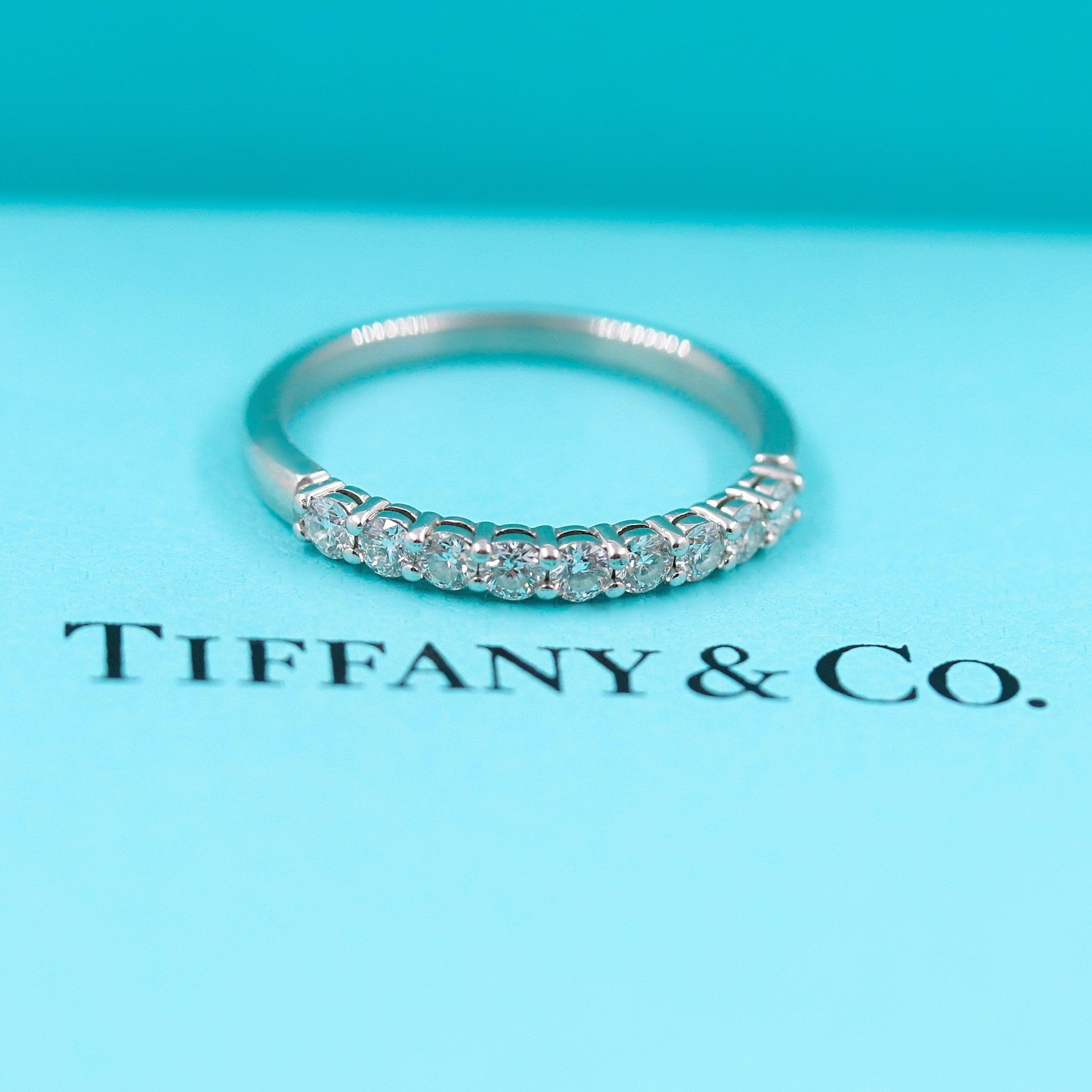 Tiffany & Co. 

Style:  Embrace Diamond Wedding Band - Half Circle
Metal:  Platinum PT950 
Width:  2.2 MM
TCW:  0.27 tcw
Size:   4.75 - sizable
Main Diamond:  9 Round Brilliant Diamonds
Color & Clarity:  F-G / VS 
Hallmark:  TIFFANY&CO.