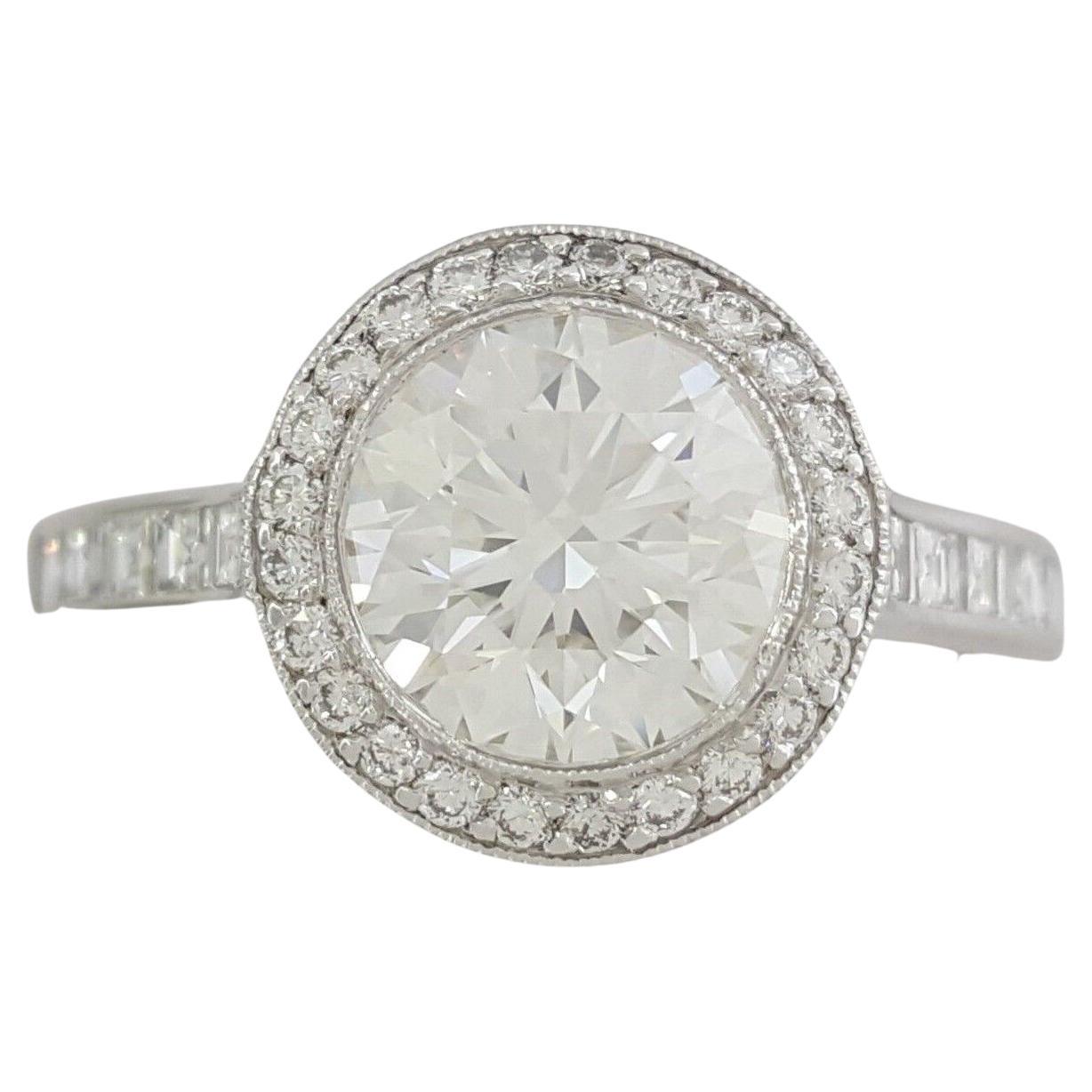 Tiffany & Co. Embrace 2.09 ct Total Weight Platinum Ideal Triple Excellent Round Brilliant Cut Diamond Halo Engagement Ring. 

The ring weighs 4.9 grams, size 7.5, the center stone is a Natural Round Brilliant Cut diamond weighing 1.54 ct, G in