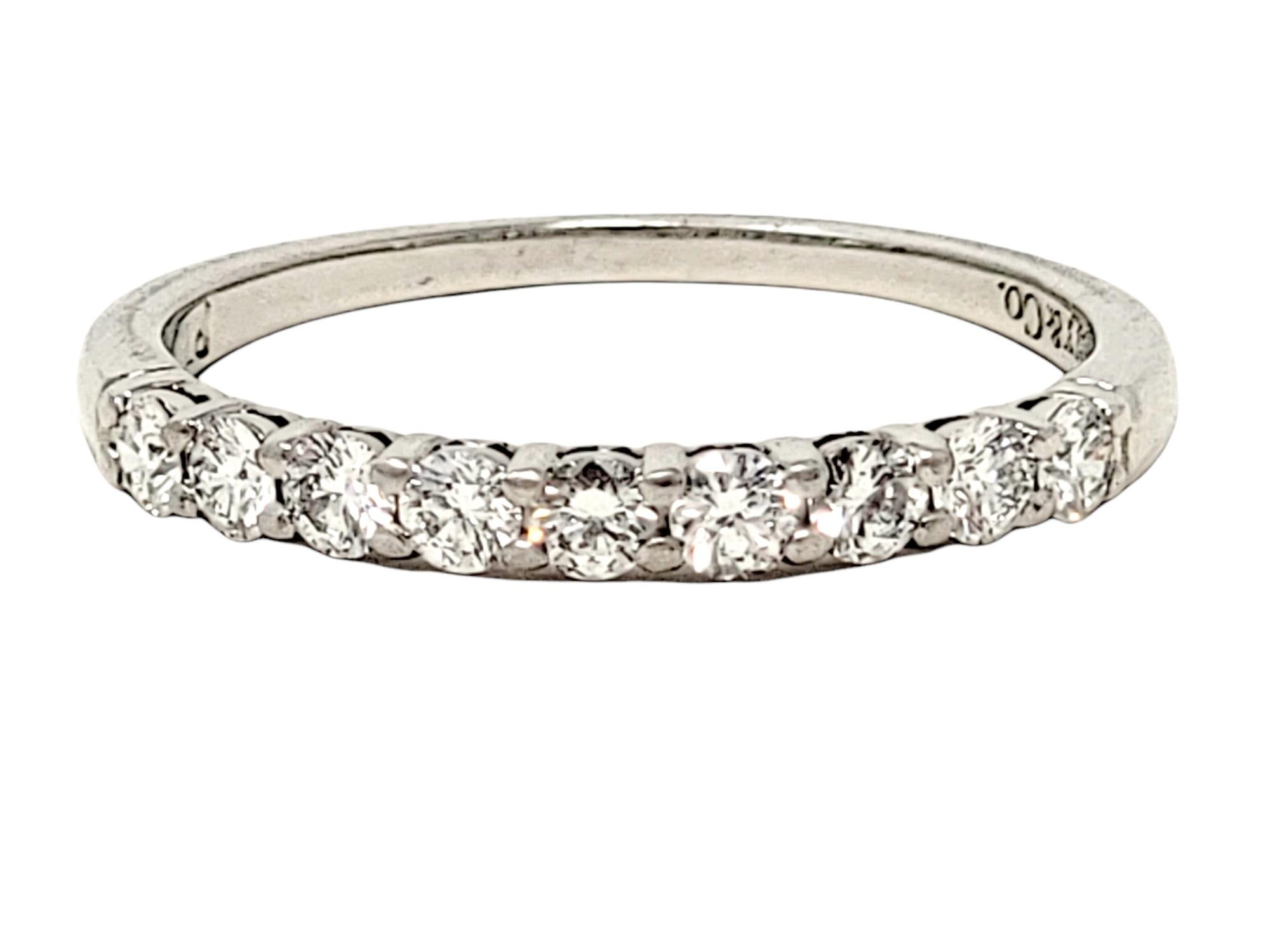Ring size: 4.5

Stunning Tiffany & Co. diamond 'Embrace' band ring. This timeless beauty features icy white round diamonds prong set along the top half of the ring in a single elegant row. It would be perfect paired with an engagement ring, or