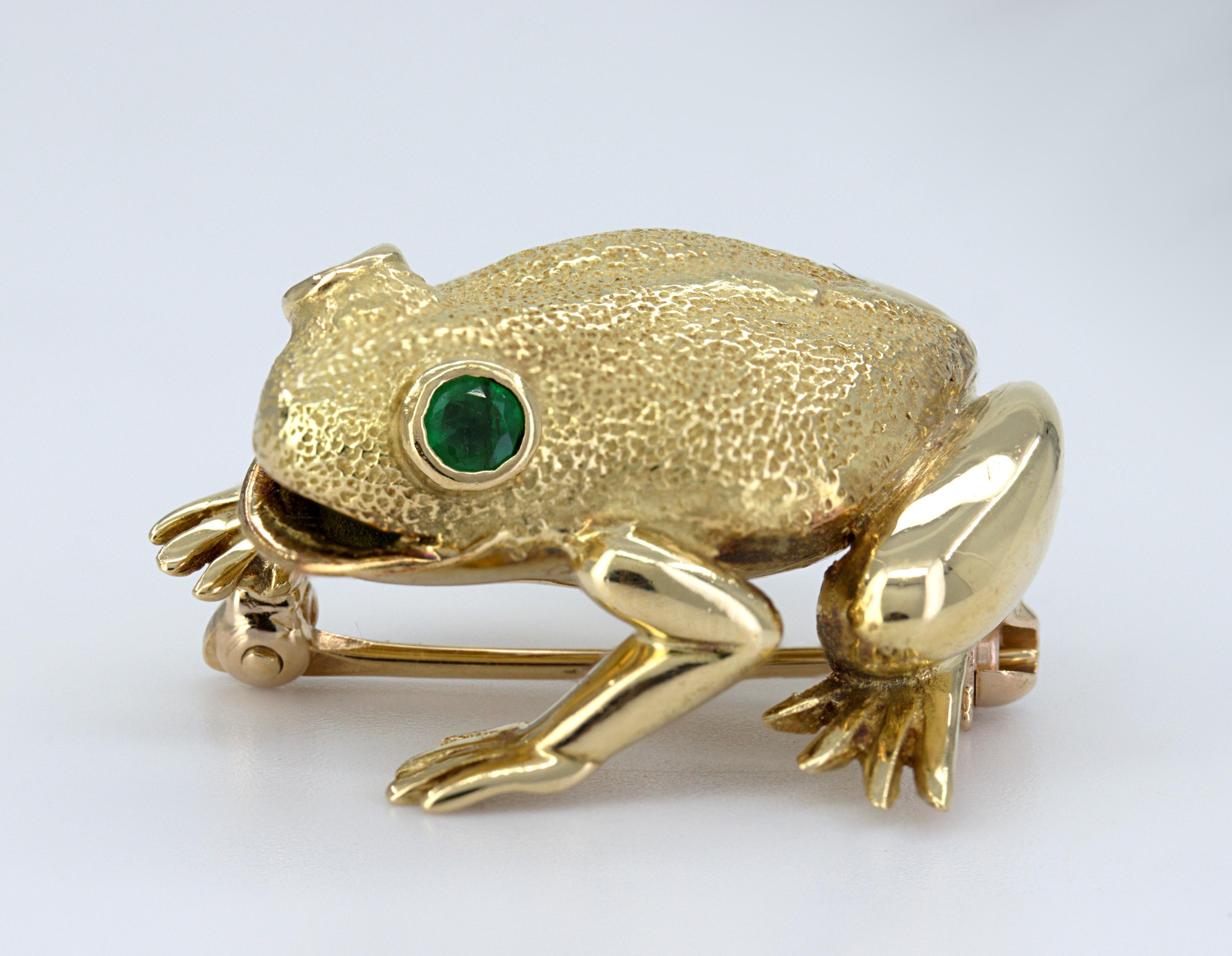 Designed as a seated frog, its eyes are (2) round-cut emeralds, 0.10 ct., tw, set in an 18k yellow gold texture mounting, 21 X 22.6 X 11 mm, marked TIFFANY & CO., 18K, S-McT, Gross weight 8.28 grams.
