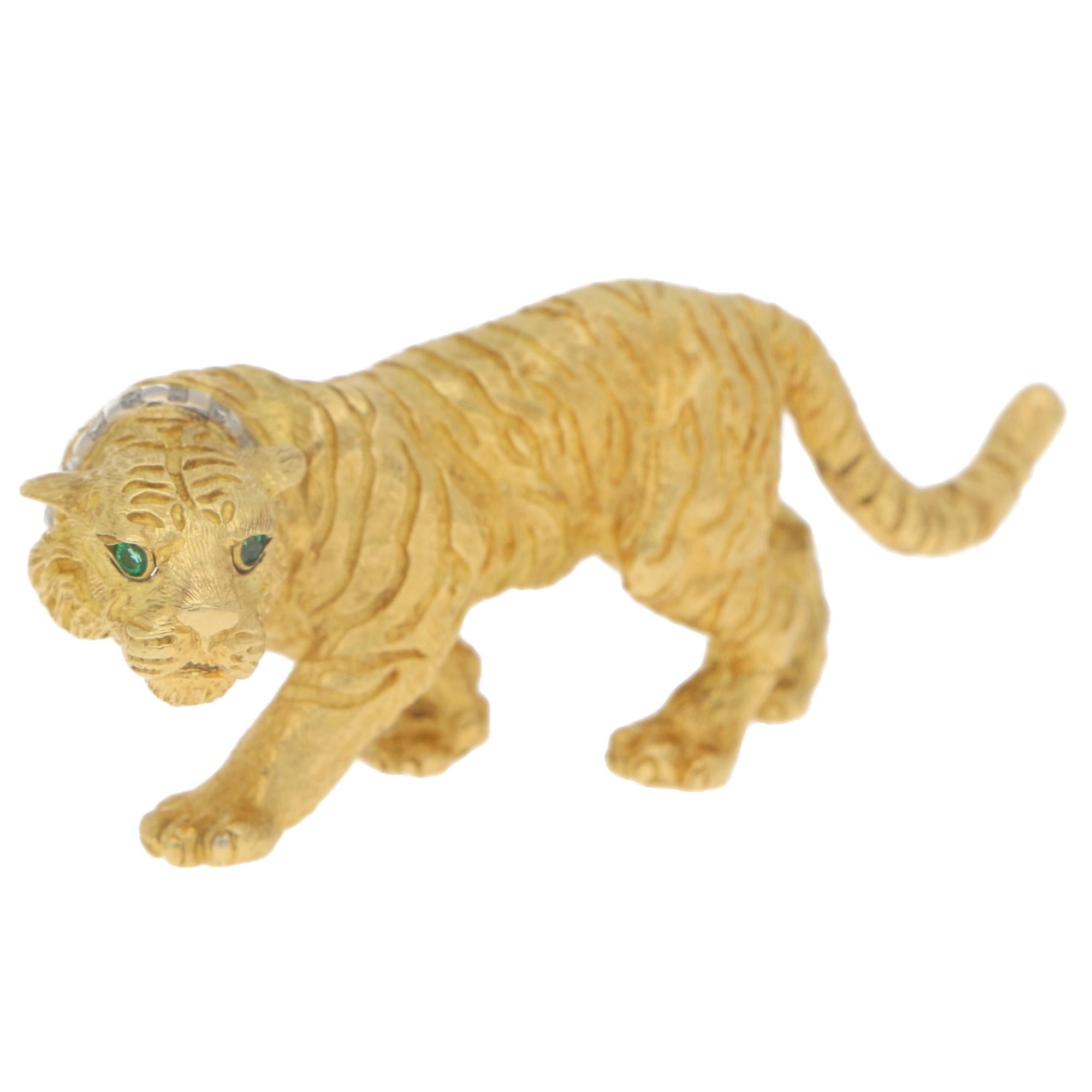 A simply stunning Tiffany & Co emerald and diamond tiger brooch set in solid 18k yellow gold; circa 1991. This brooch is a beautiful example of vintage Tiffany & Co craftsmanship and design!

The brooch depicts a walking/creeping tiger and is made