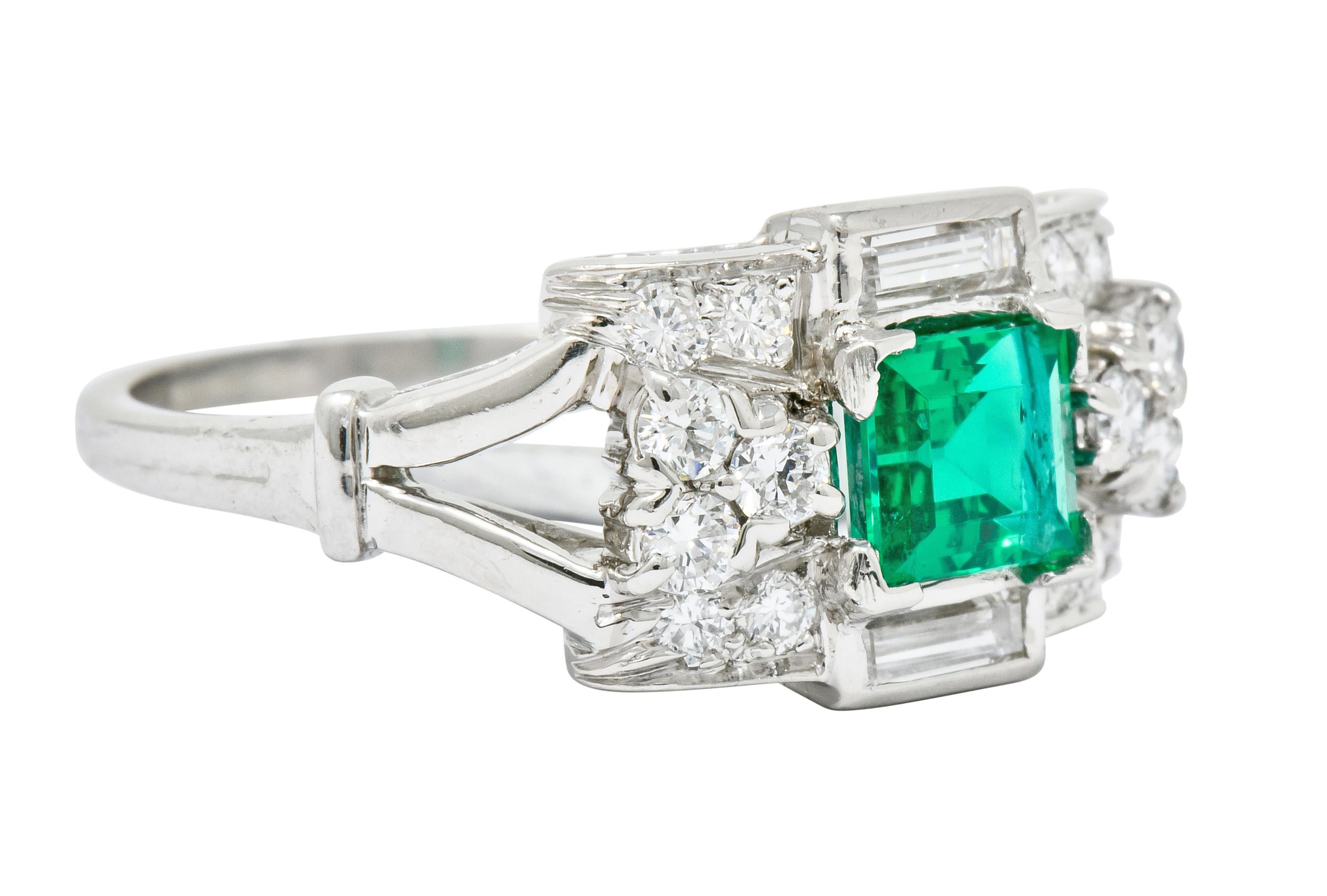 Designed as a rectangular mounting centering an emerald cut emerald weighing approximately 0.80 carat; transparent with bright saturated green coloring

With two baguette cut diamonds, bezel set North and South of emerald, weighing approximately