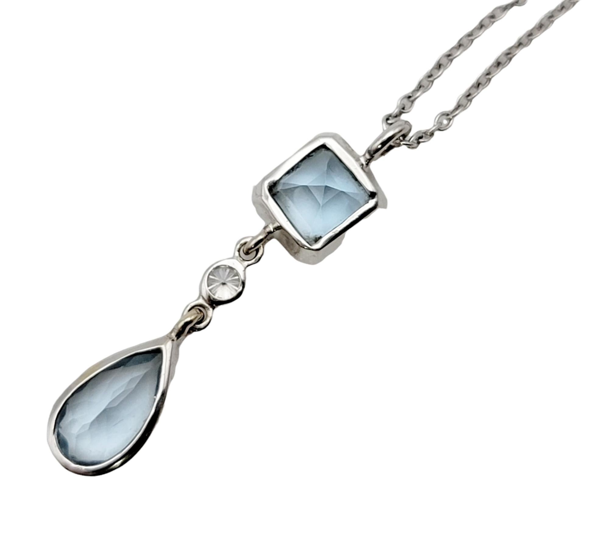 This lovely aquamarine and diamond drop pendant necklace from Tiffany & Co. offers the perfect hint of sparkle and color to your look. This pretty piece features two natural bezel set aquamarine stones set in a vertical layout on a delicate white